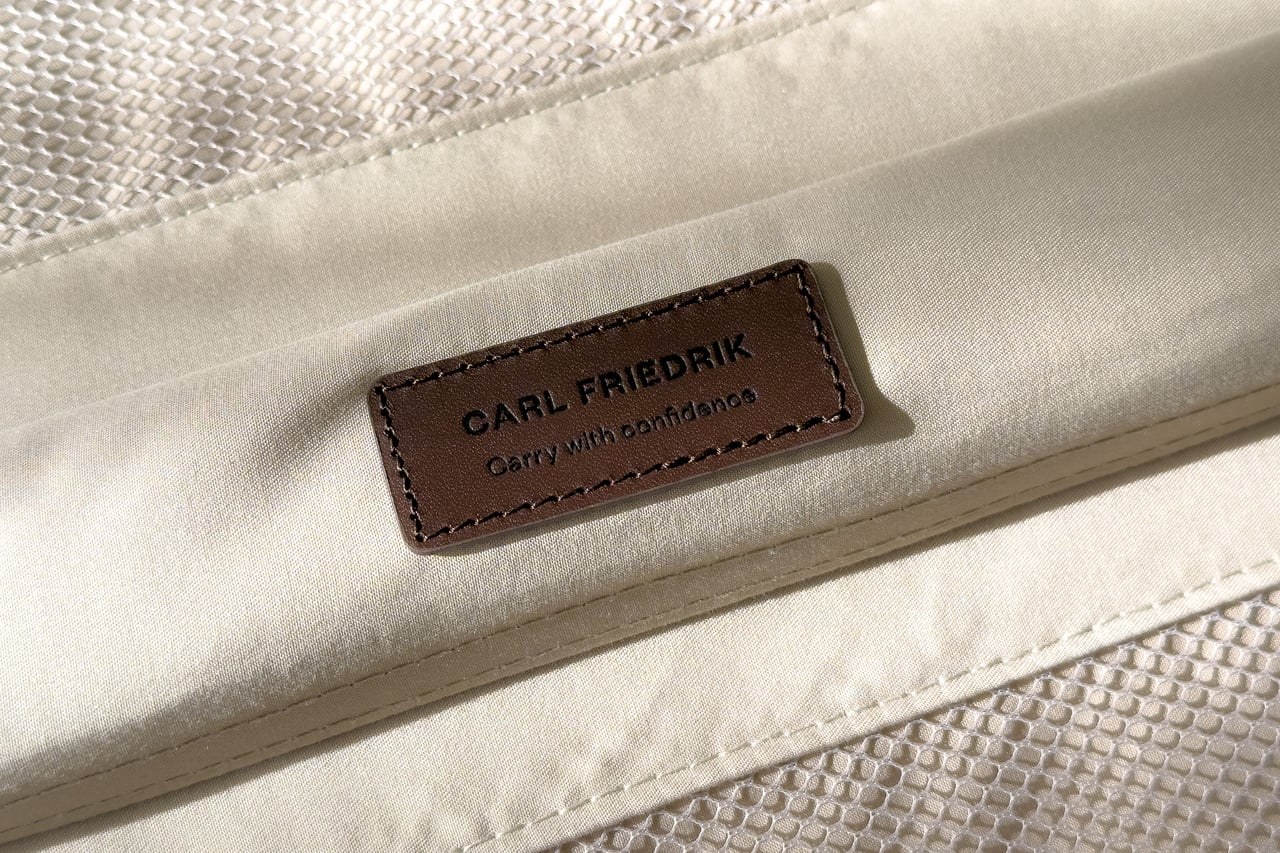 Leather Carl Friedrik tag stamped Carry with confidence on the suitcase lining - Luxe Digital