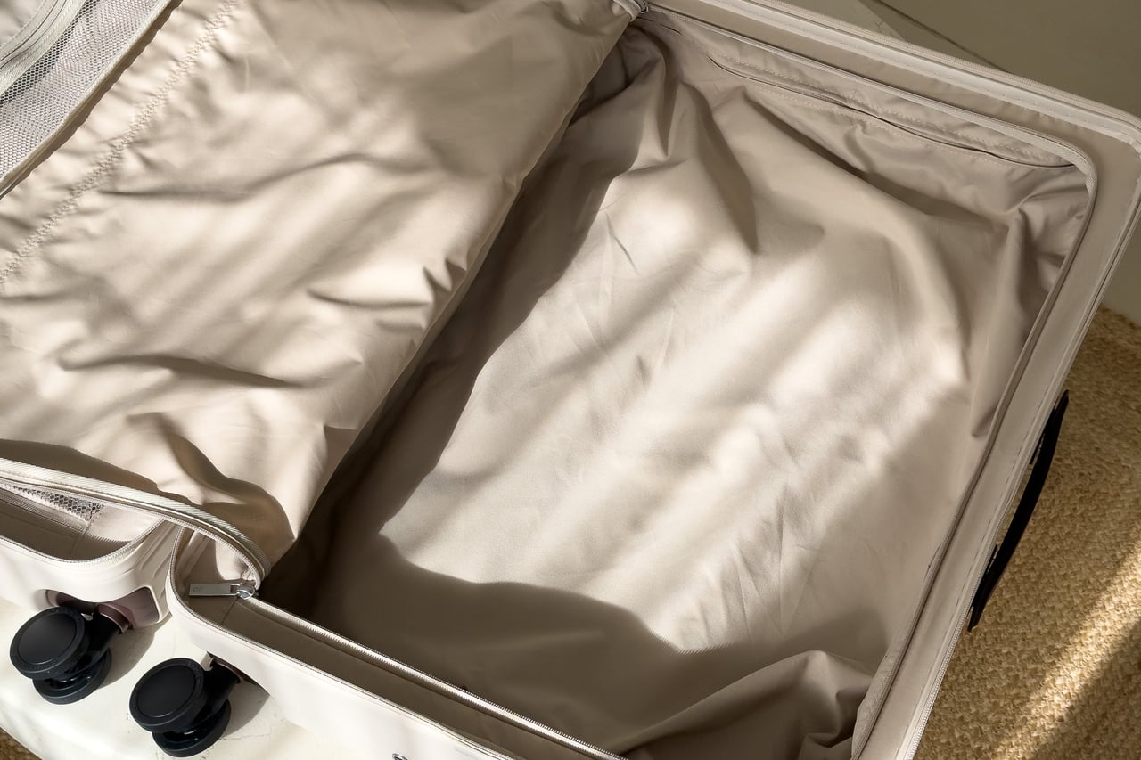 Padded lining over the handle rails inside the Carl Friedrik suitcase - Luxe Digital