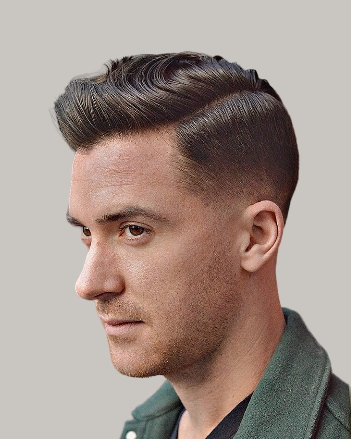 Man with an Ivy League haircut and a side part, seen at an angle