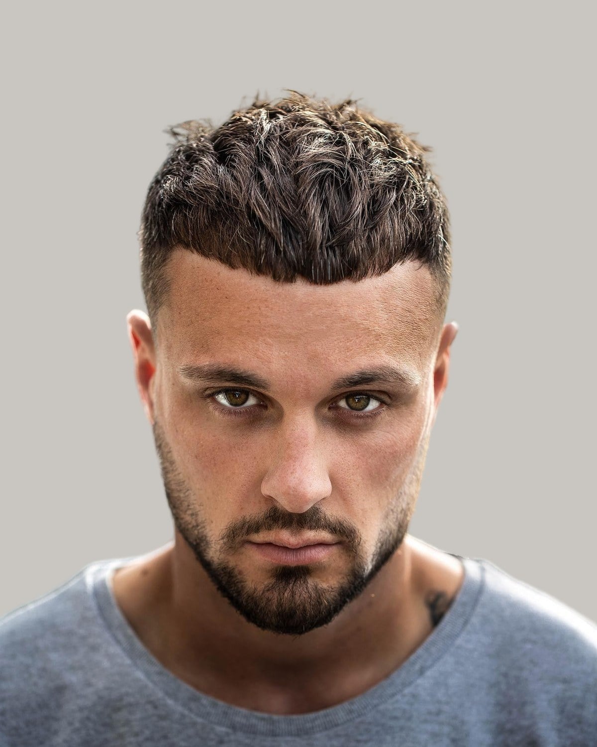 Bearded man with a messy crew cut, seen from the front