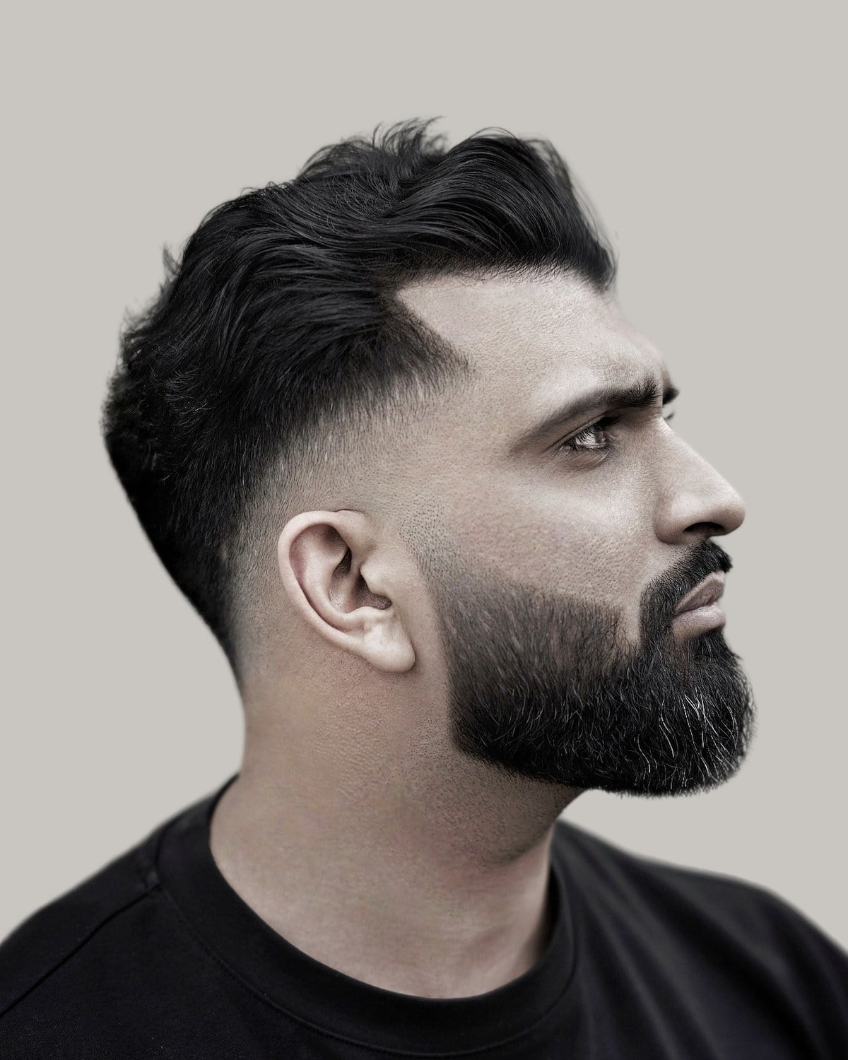 Bearded man with a modern crew cut, seen in profile