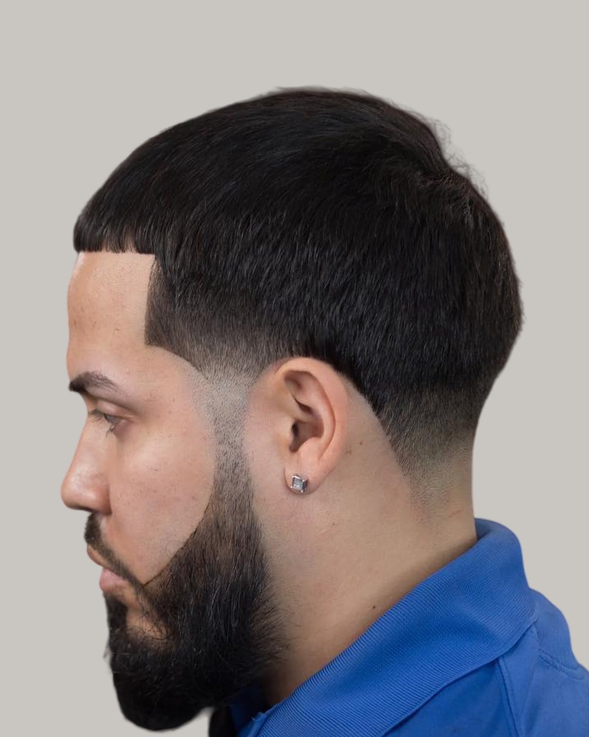 Bearded man with a tapered crew cut, seen in profile