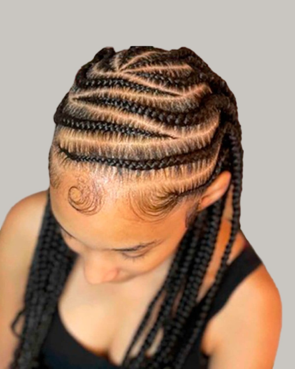 Woman in a black top looking down, Fulani braids with rows curving across the crown