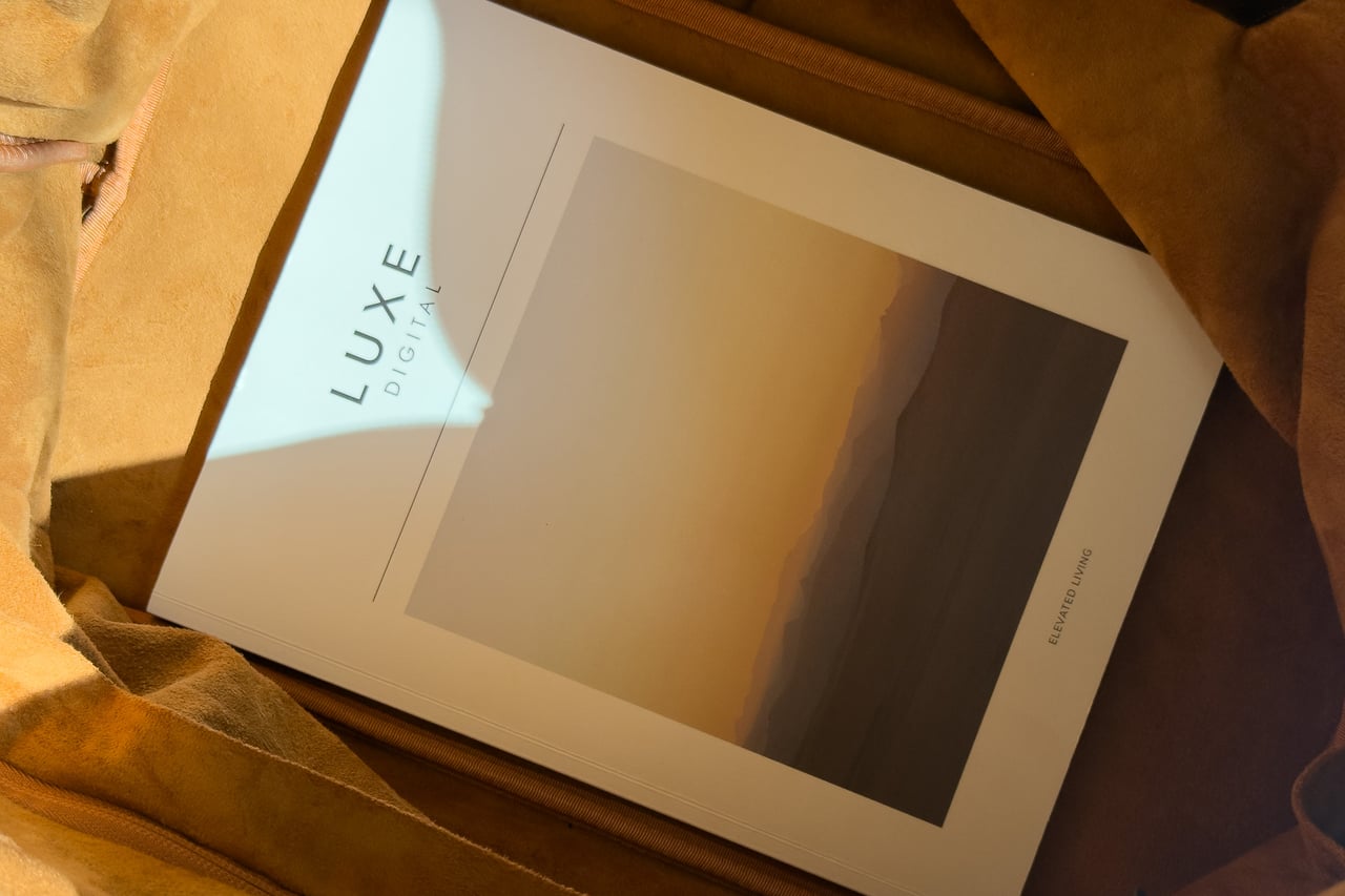 A Luxe Digital magazine lying flat on the microsuede base inside the Harber London Leather Overnight Bag - Luxe Digital