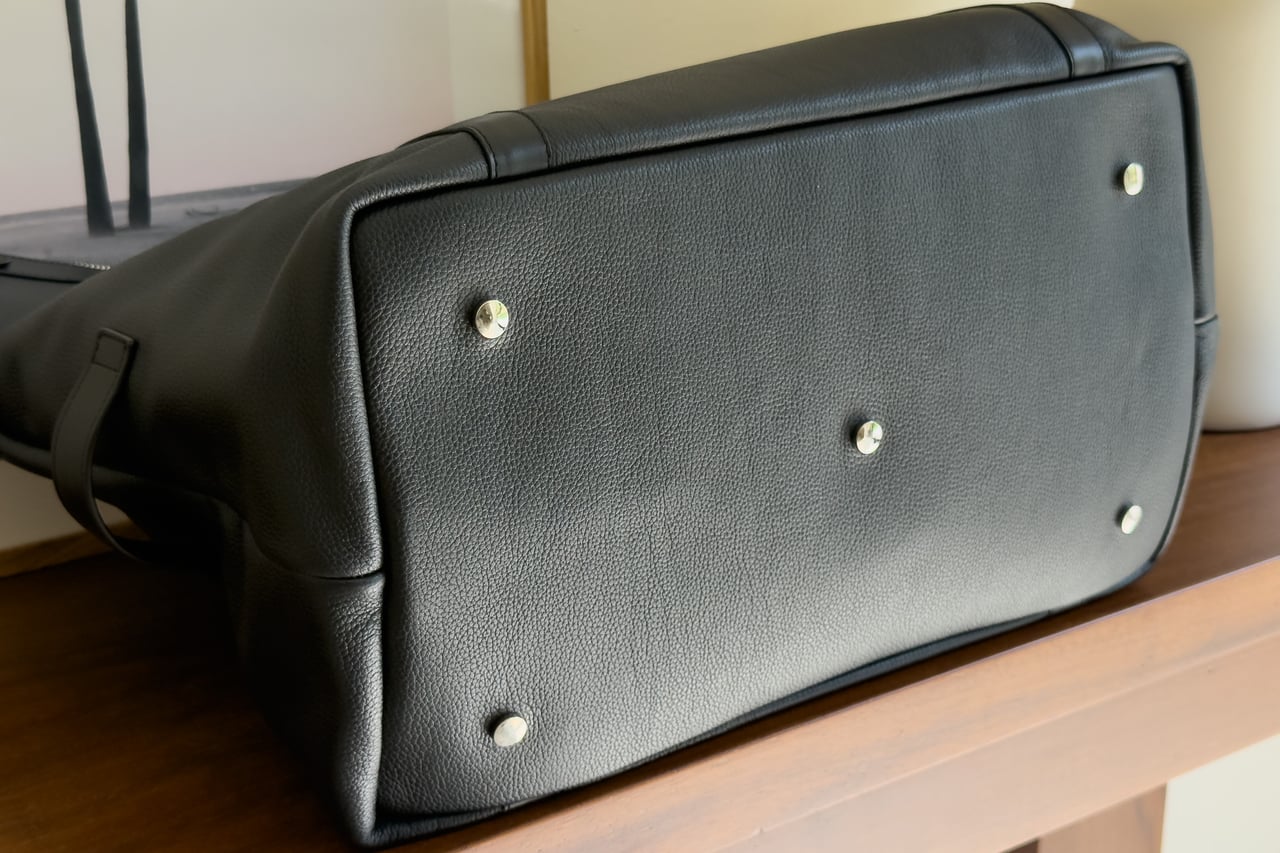Five metal feet on the leather base of the Harber London Leather Overnight Bag - Luxe Digital