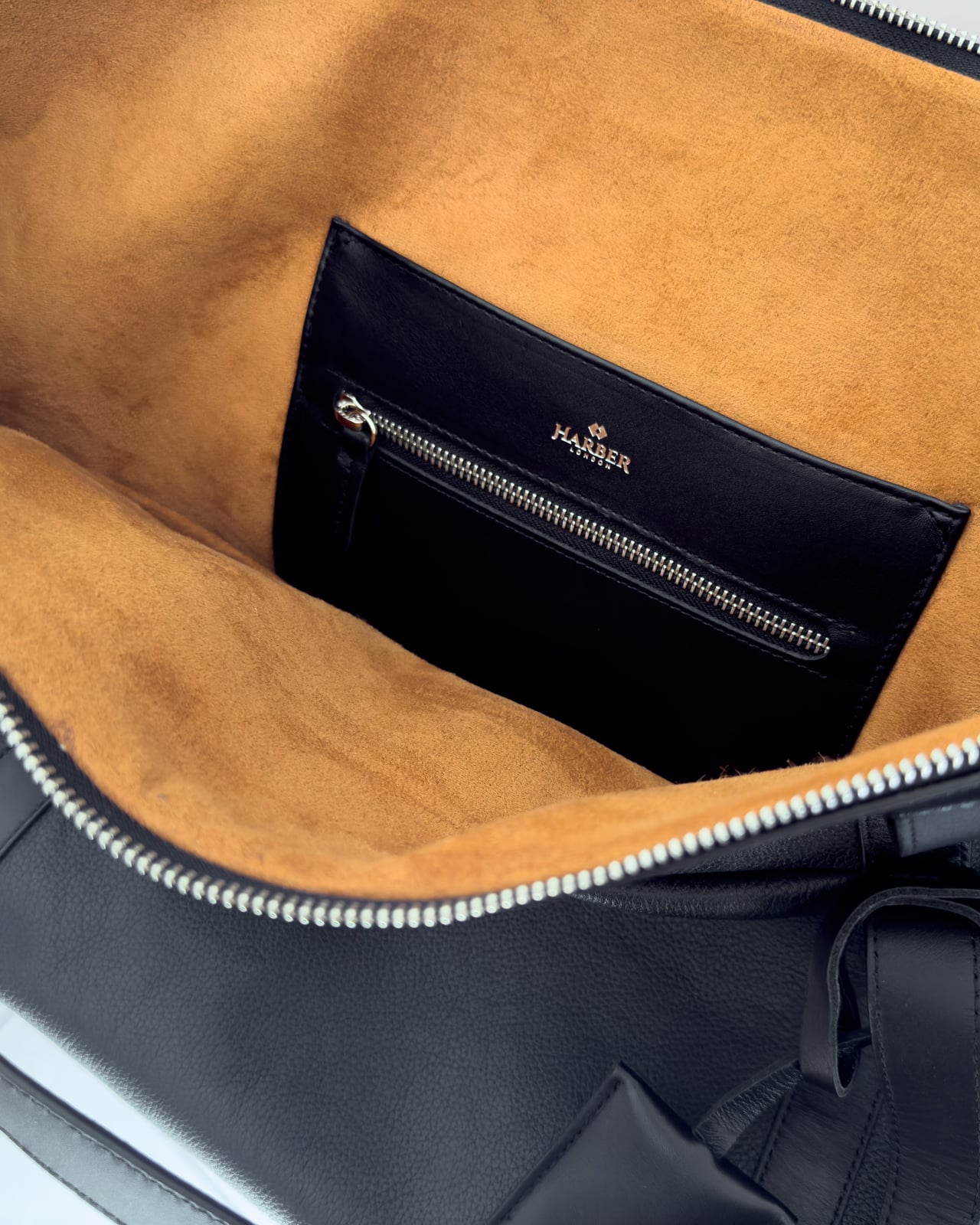 Tan microsuede lining and black leather zipped pocket inside the Harber London Leather Overnight Bag - Luxe Digital