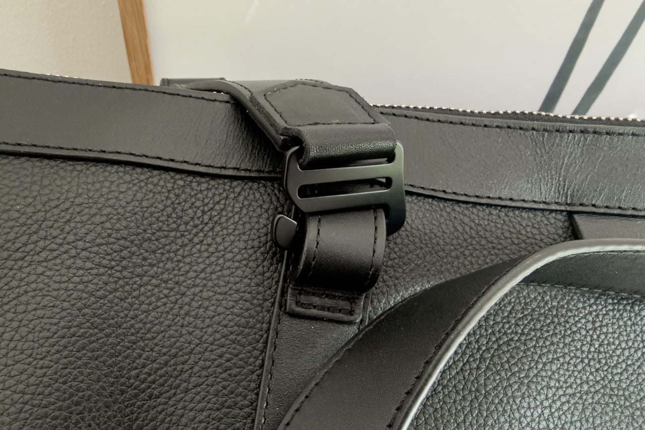 Black metal buckle on a leather end strap of the Harber London Leather Overnight Bag - Luxe Digital