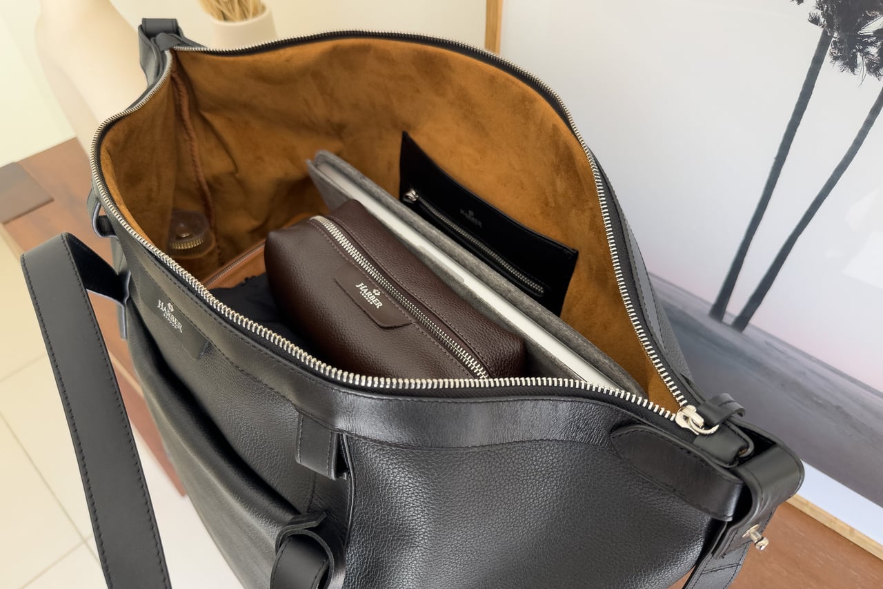 Open Harber London Leather Overnight Bag packed with a leather dopp kit and a laptop in a separate protective sleeve - Luxe Digital