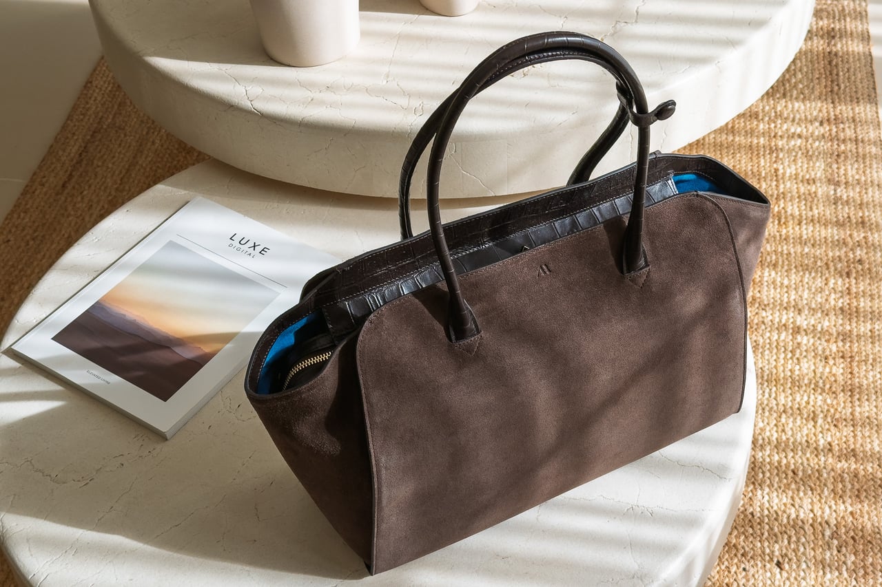 KAAI Voyager in Suede Espresso seen from an angle with croc-effect trim - Luxe Digital