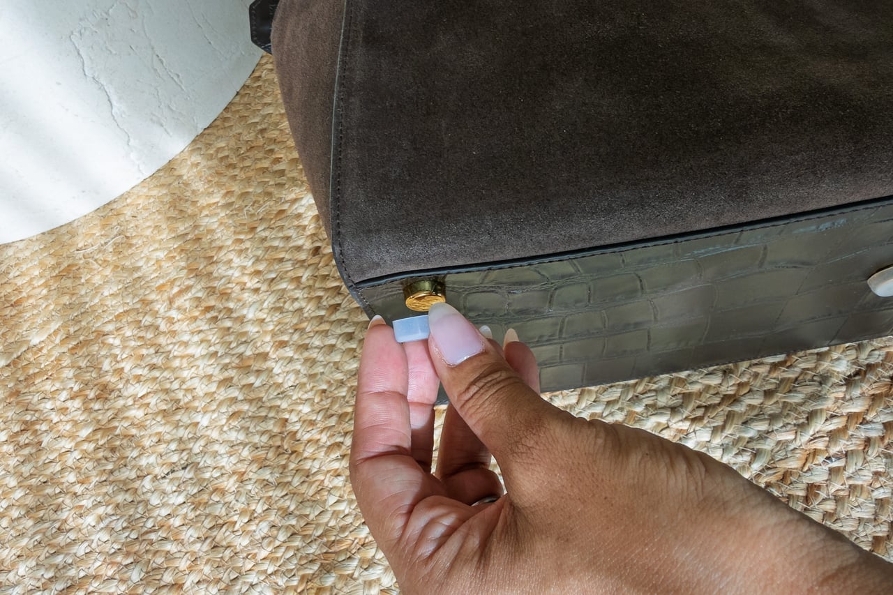 Silicone cover being removed from a metal foot on the KAAI Voyager base - Luxe Digital