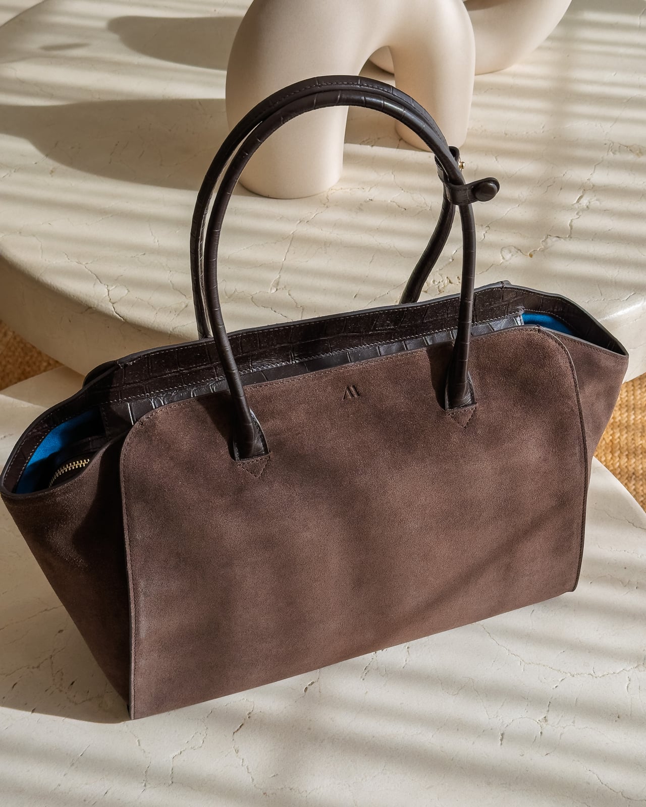 Front view of the KAAI Voyager suede tote silhouette and rolled handles - Luxe Digital