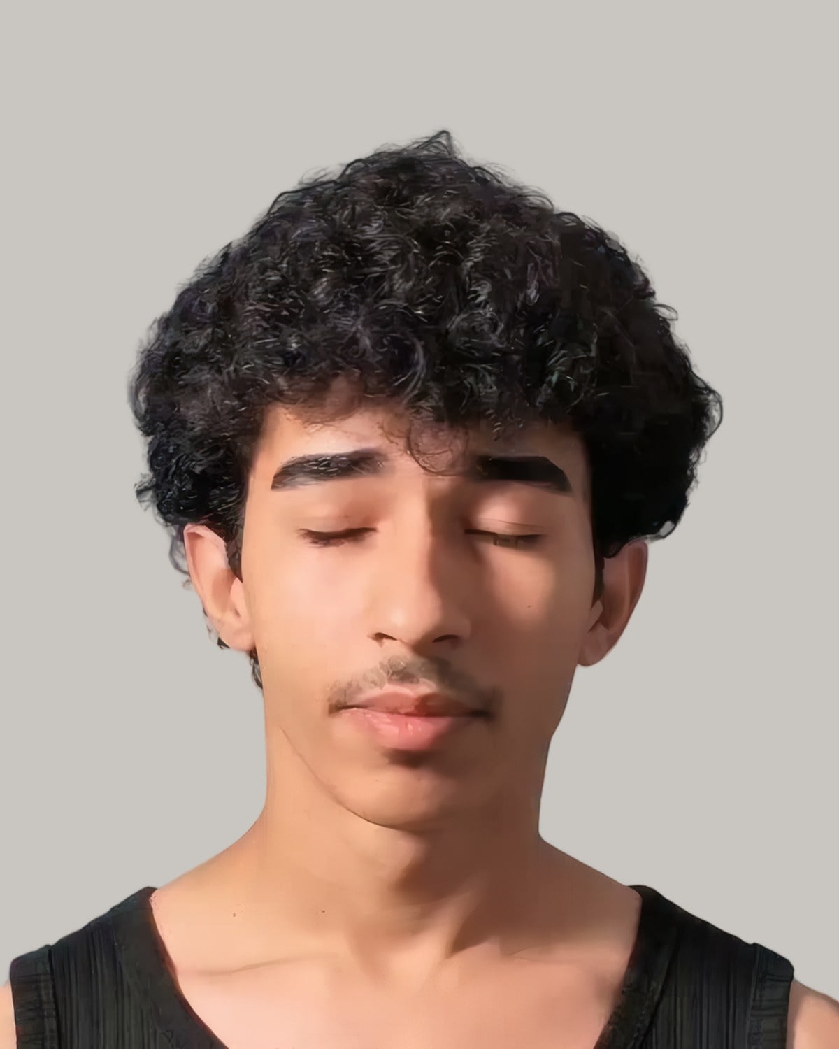 Young man with a full top of dark curls, seen from the front