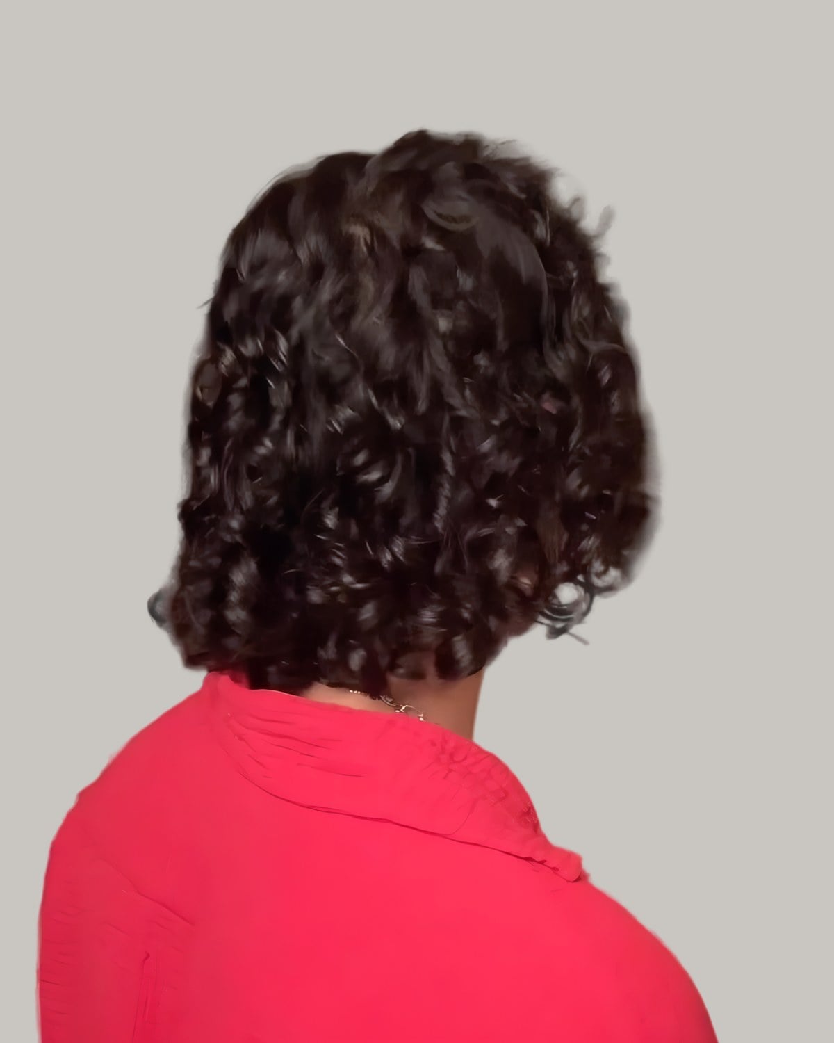 Man with long curls, seen from behind at an angle