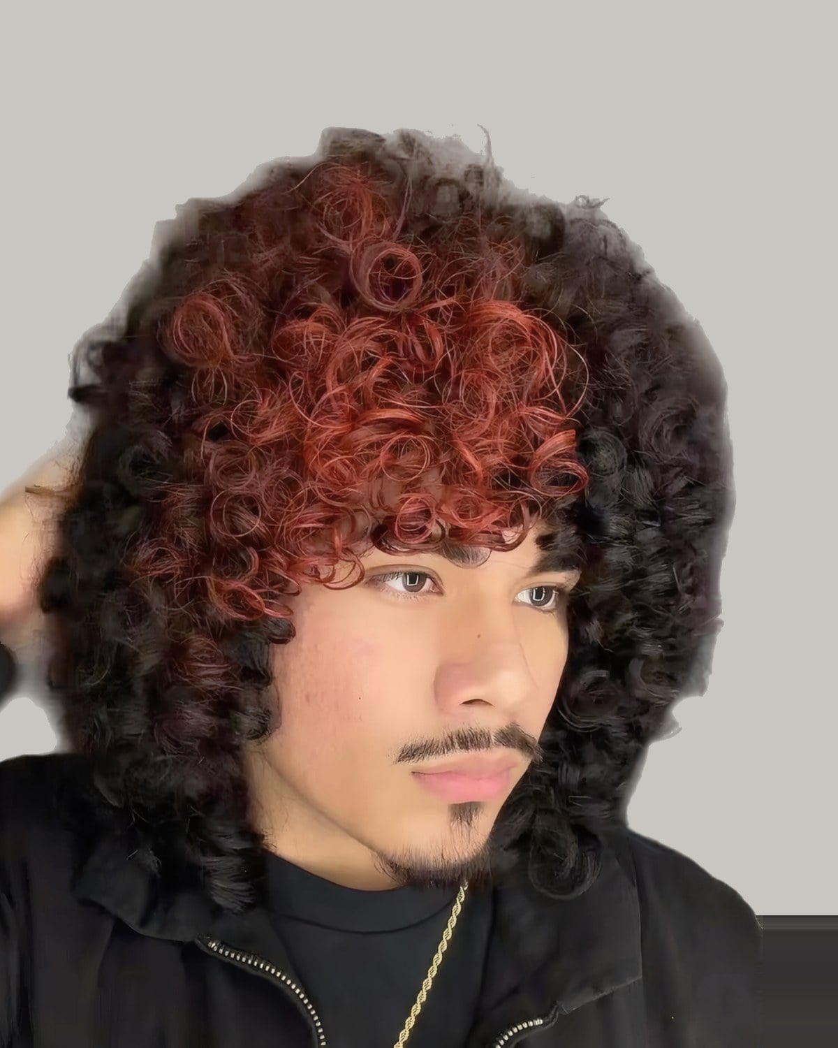 Man with long red-tinted curls and a mustache, seen from the front