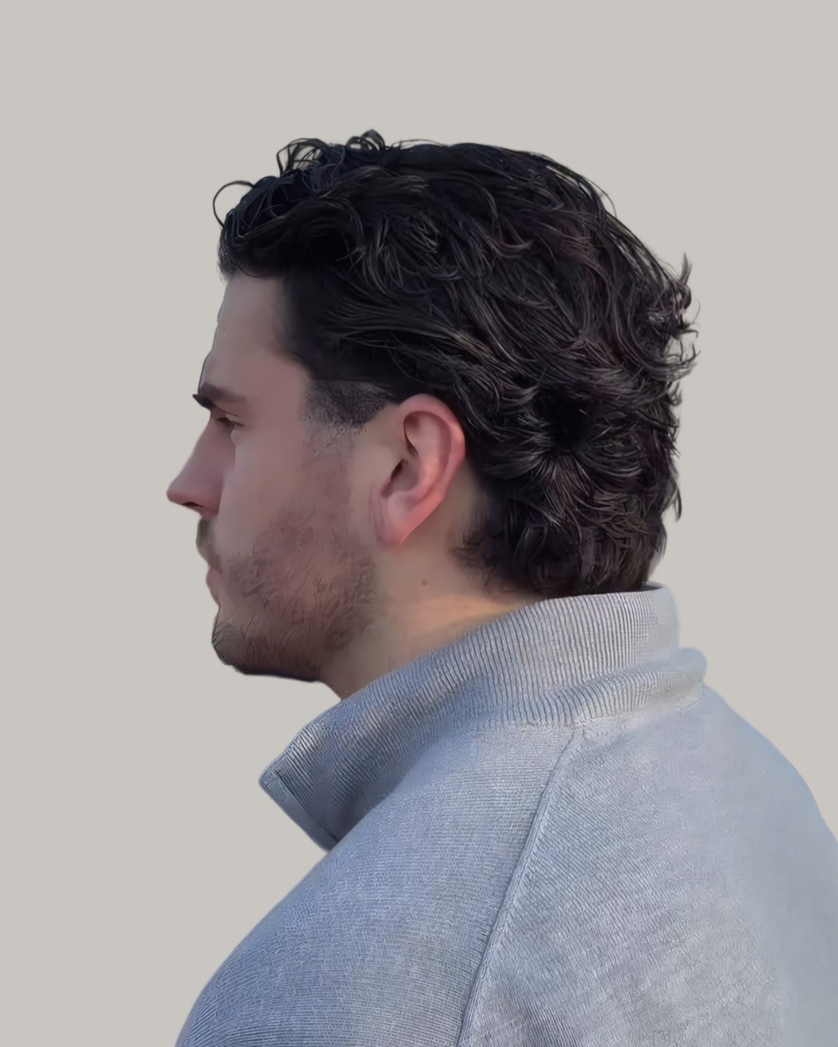 Man with dark waves swept back, seen from behind at an angle