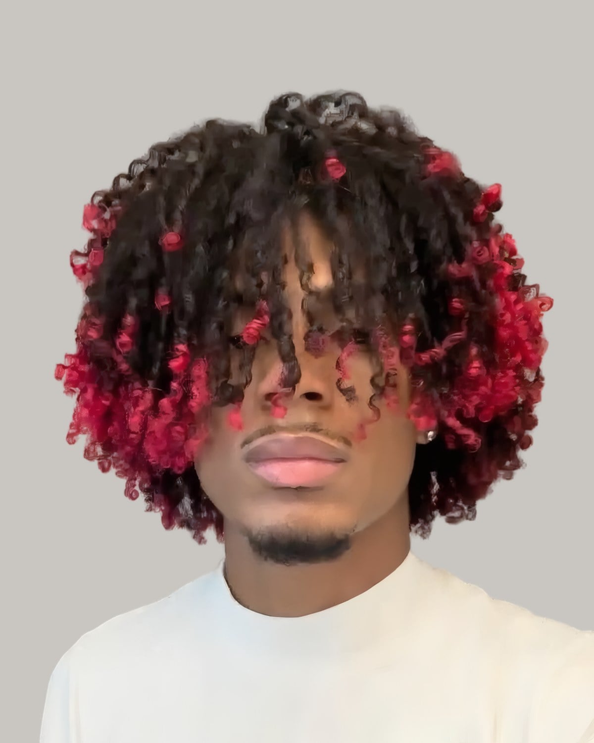 Young man with curls dyed red, seen from the front