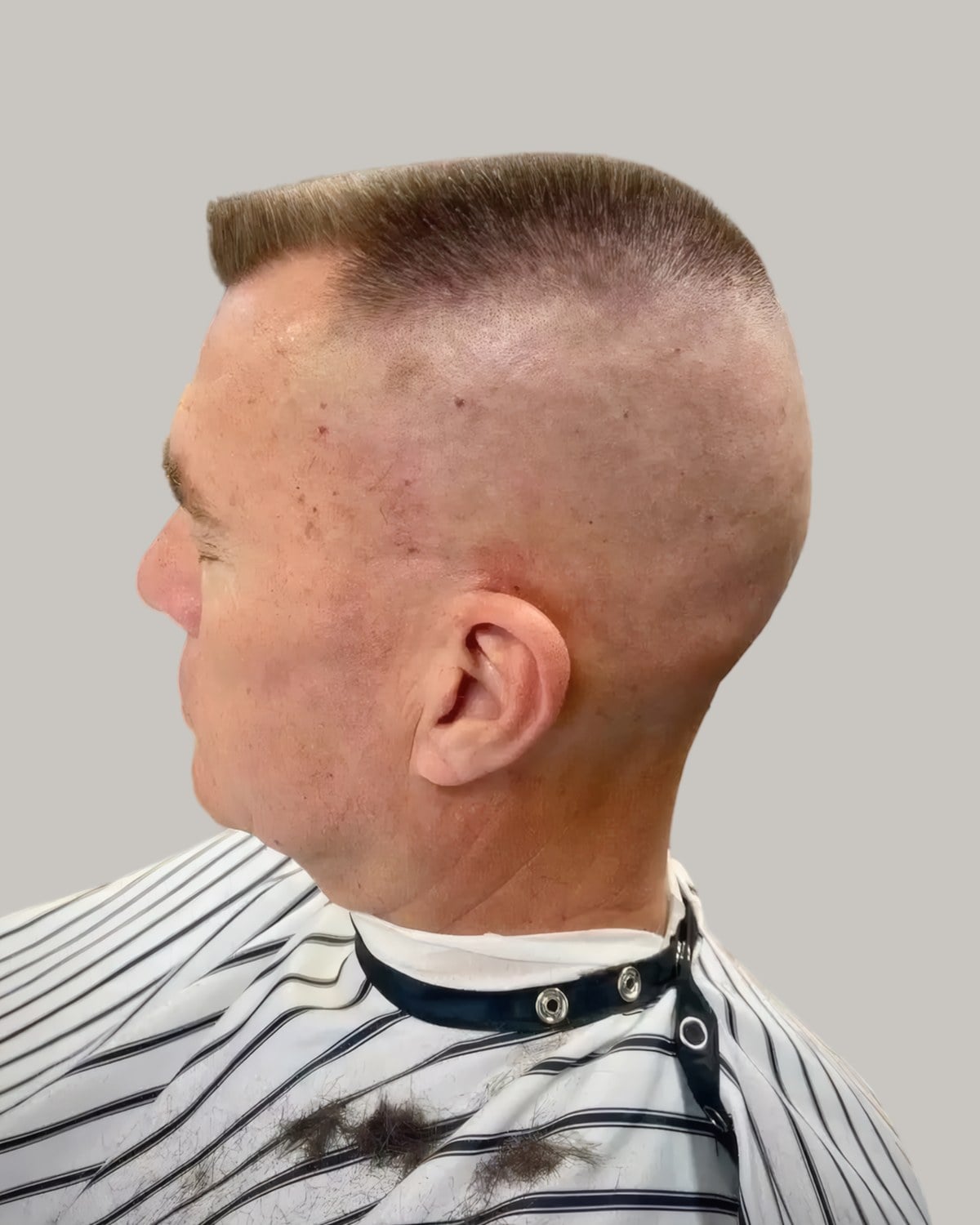 Man with a high and tight haircut, seen from behind at an angle