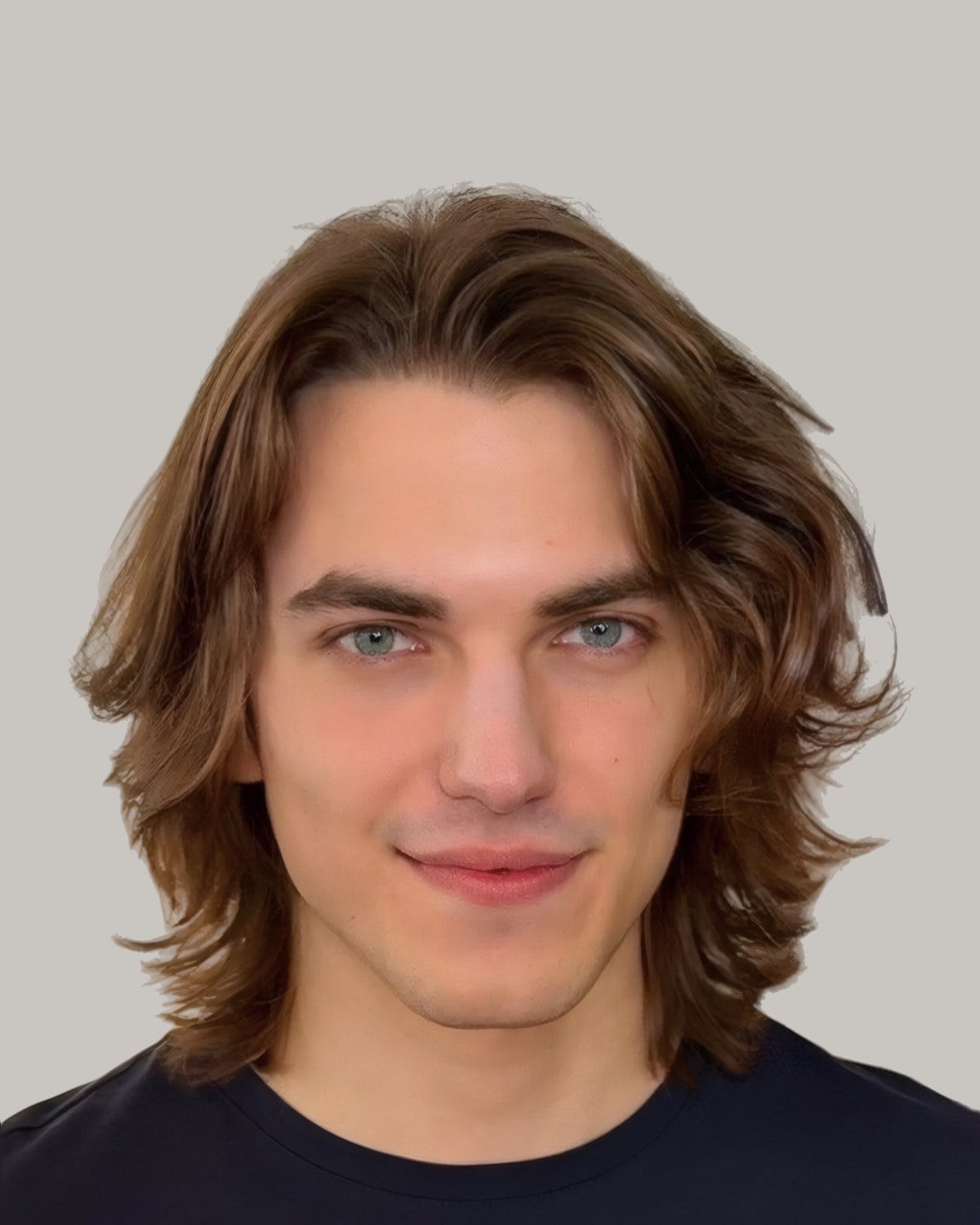 Smiling man with wavy light brown hair parted in the centre and falling to his jaw