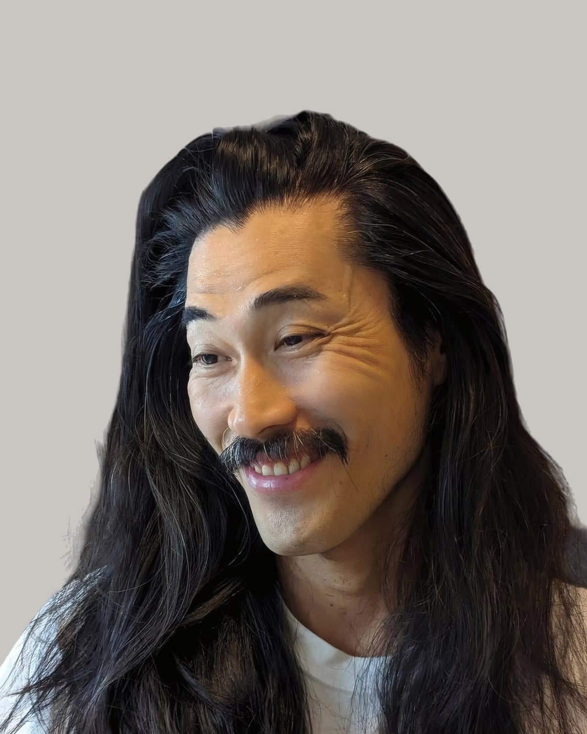 Smiling man with a moustache and long, straight black hair