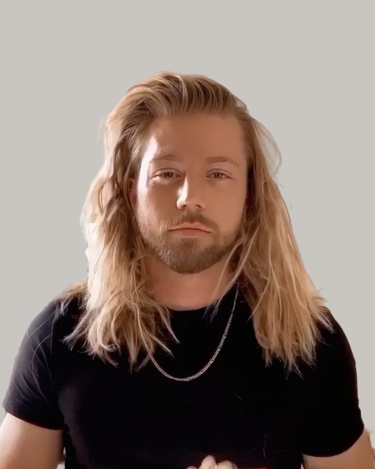 Bearded man in a black T-shirt with long blond hair swept back and falling past his shoulders