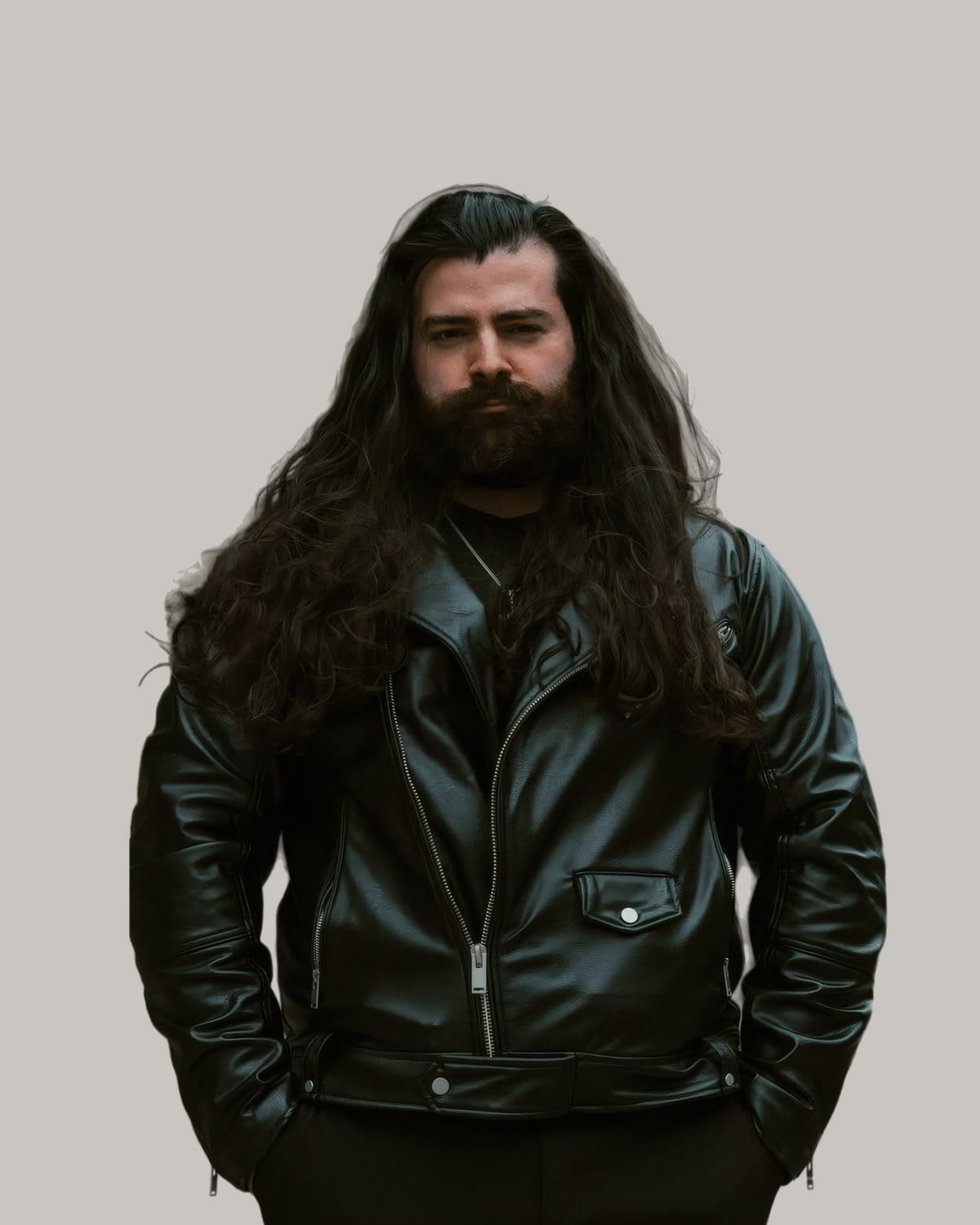 Bearded man in a leather jacket with long, wavy dark hair falling past his chest