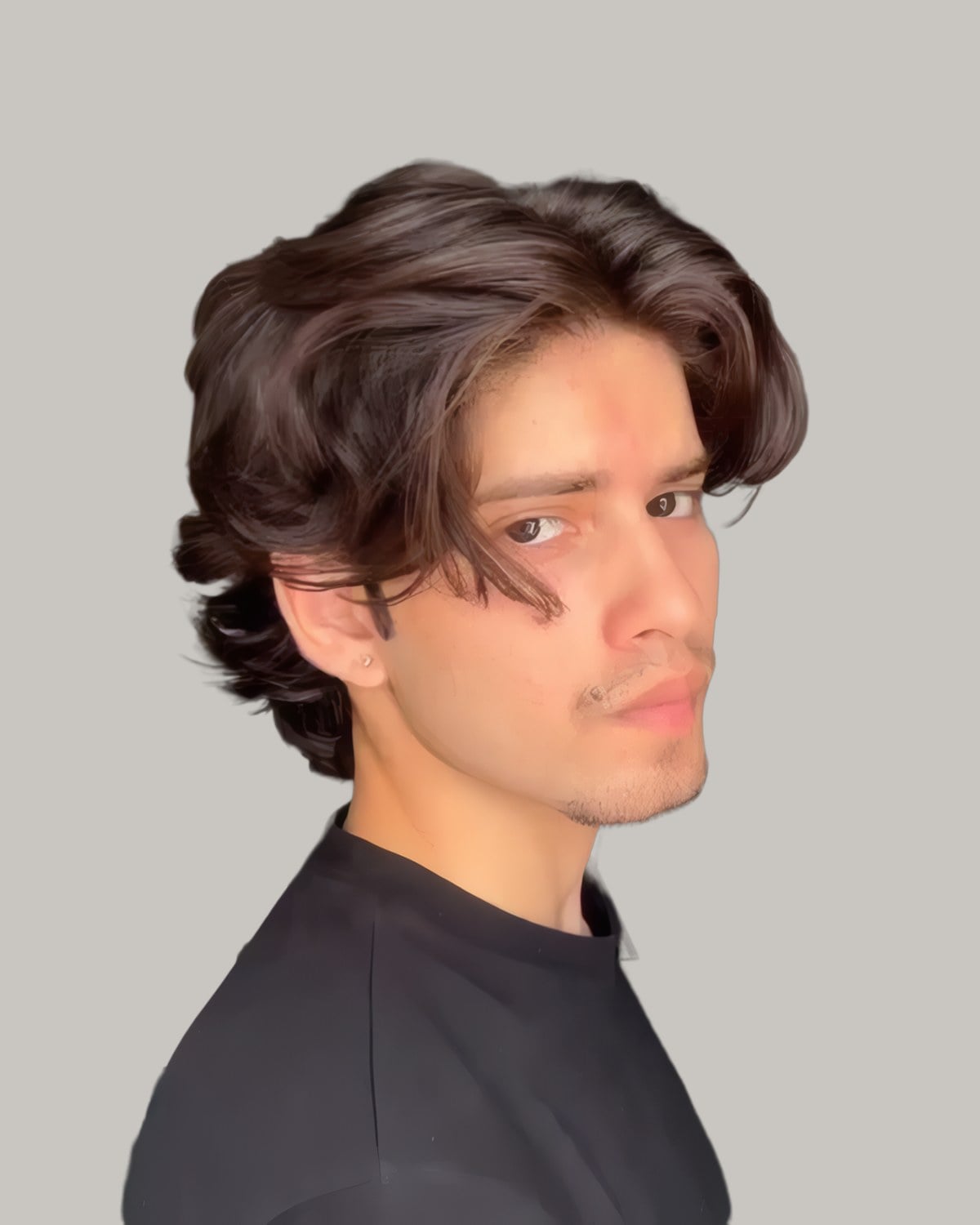 Young man with dark wavy hair falling past his ears and swept back, in a black top