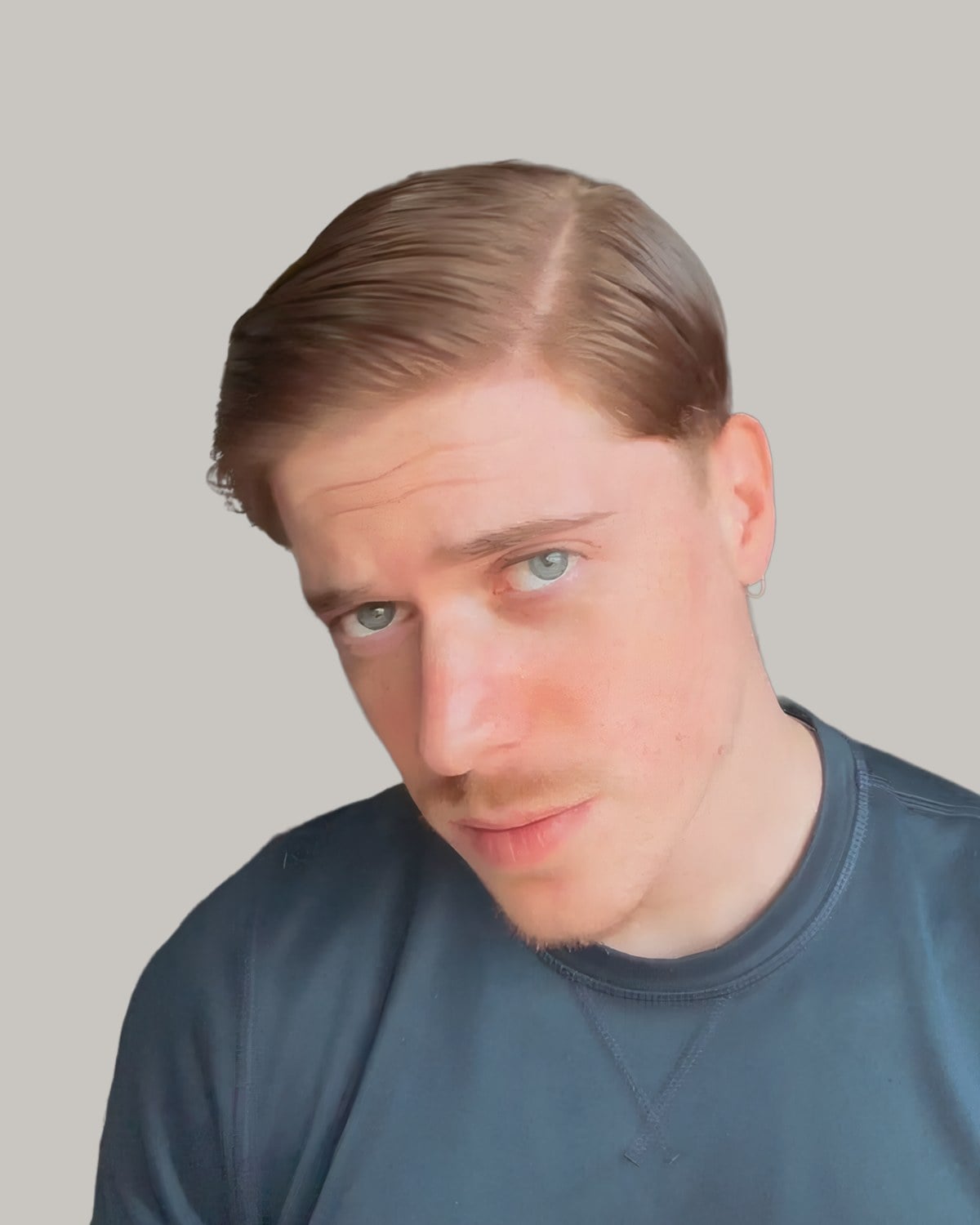 Man with blond hair combed into a neat side part