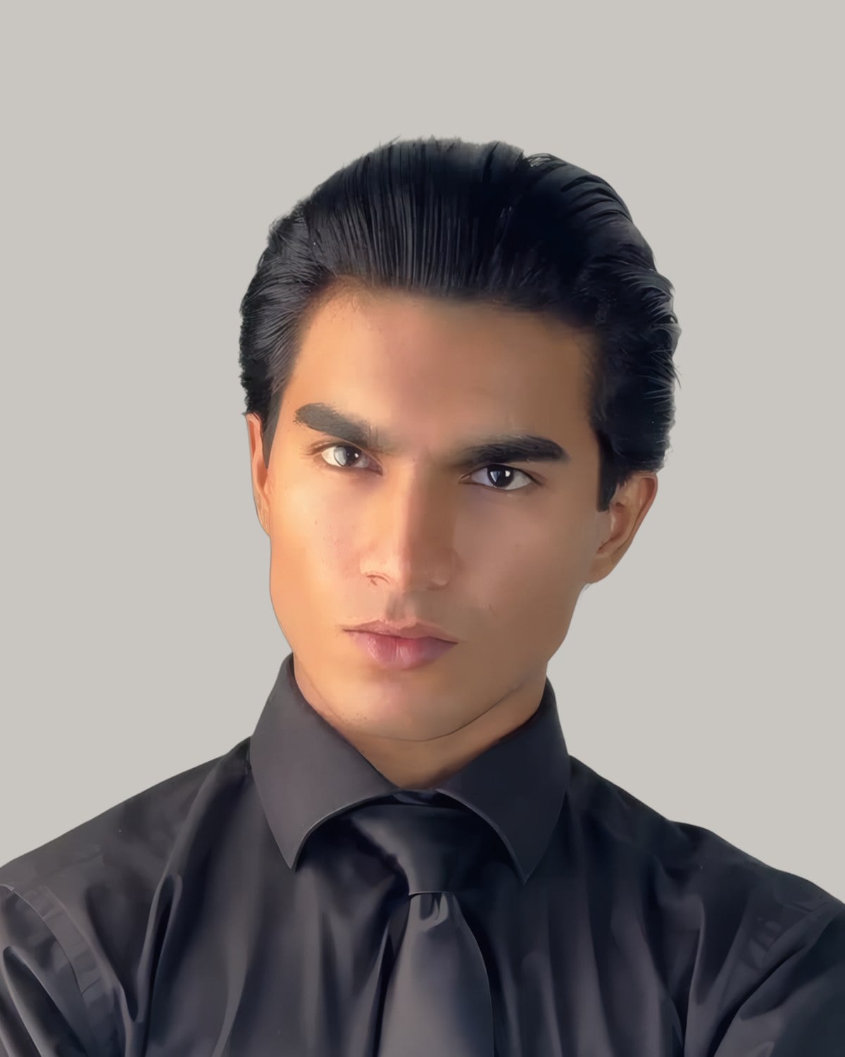 Young man with glossy black hair slicked back, in a black shirt and tie