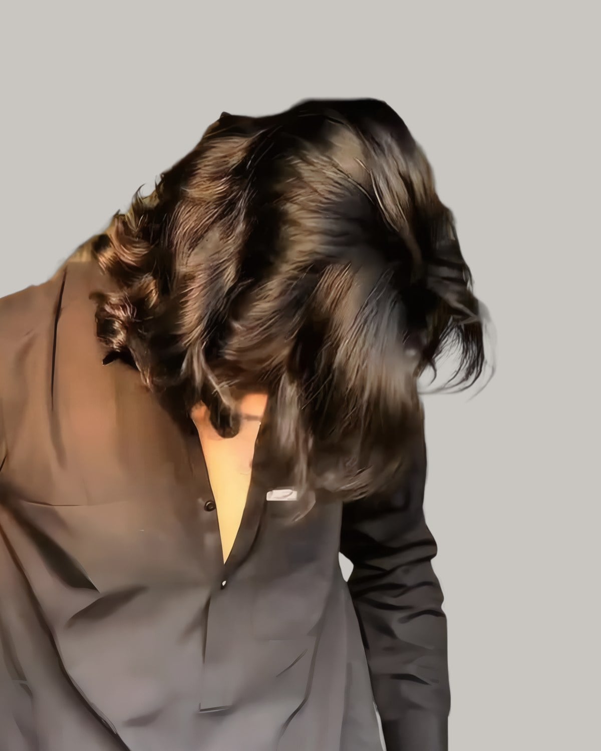 Man with long dark hair falling past his shoulders in loose waves, seen from the side