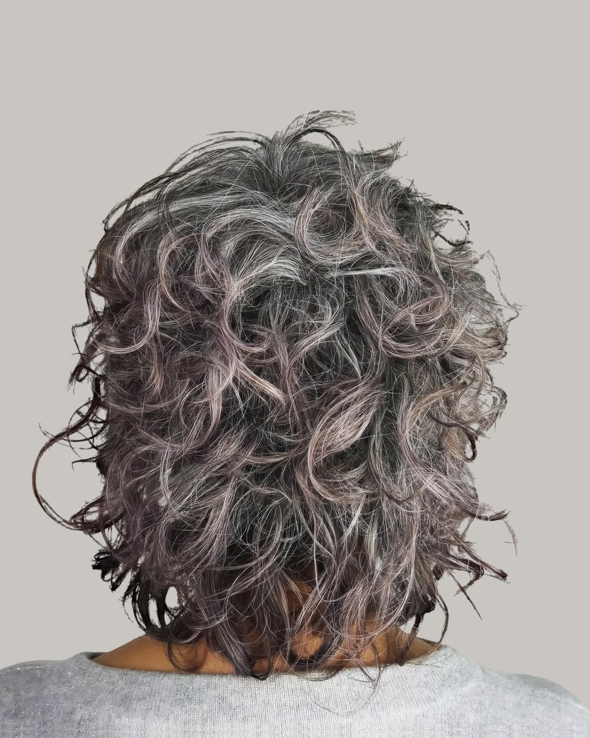 Back view of a jaw-length gray curly shag