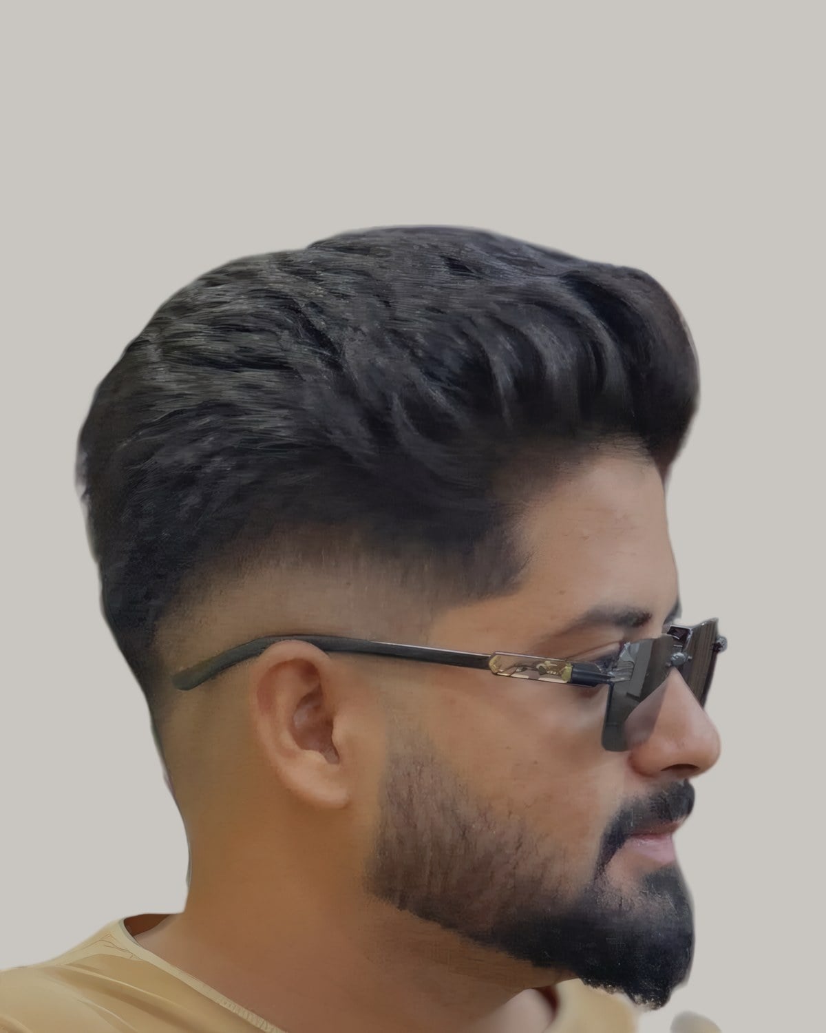 Bearded man in glasses with a textured top and a fade, seen from the front