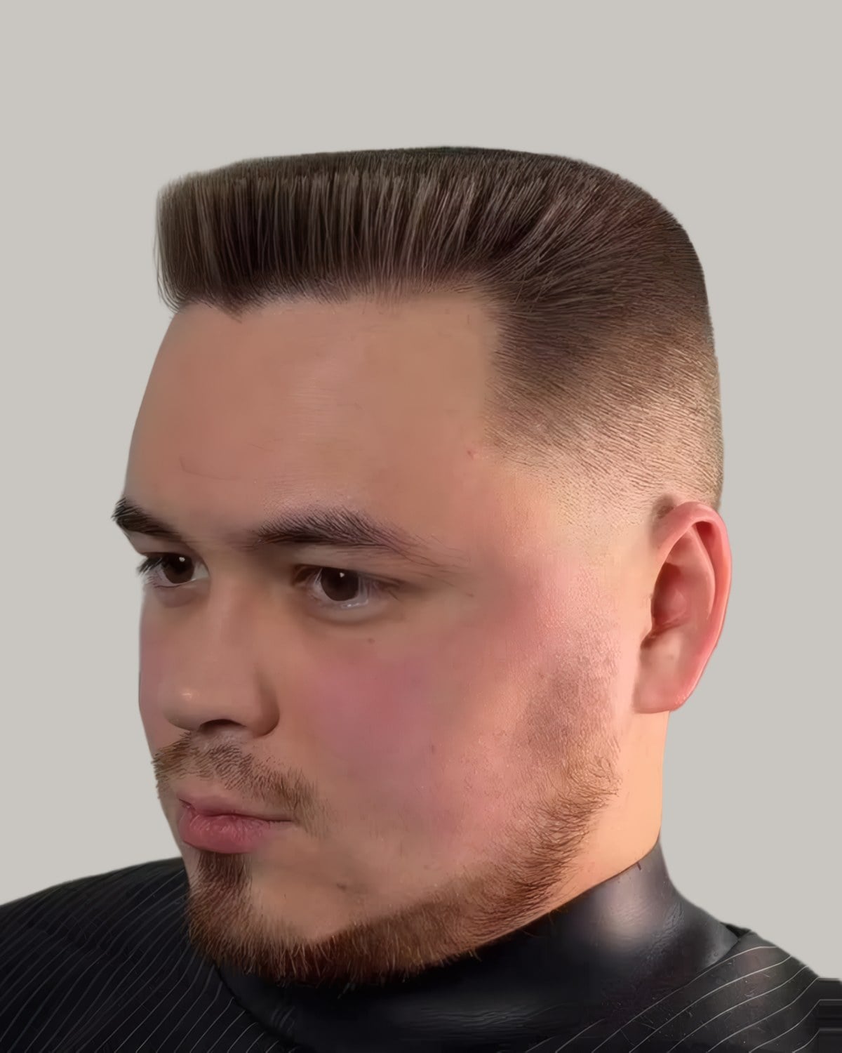 Man with a flat top and short faded sides, seen from the front