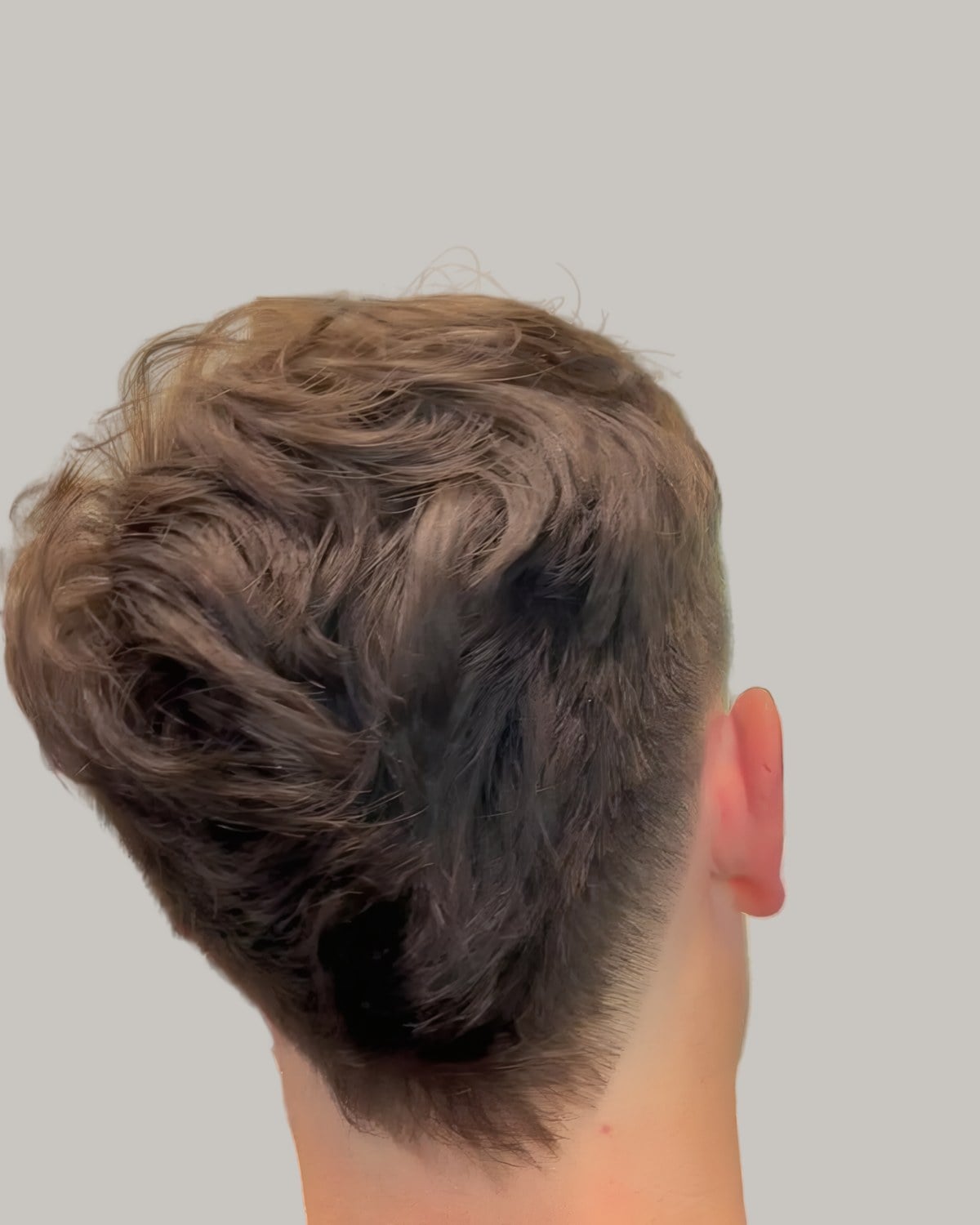 Man with a tousled textured top, seen from behind