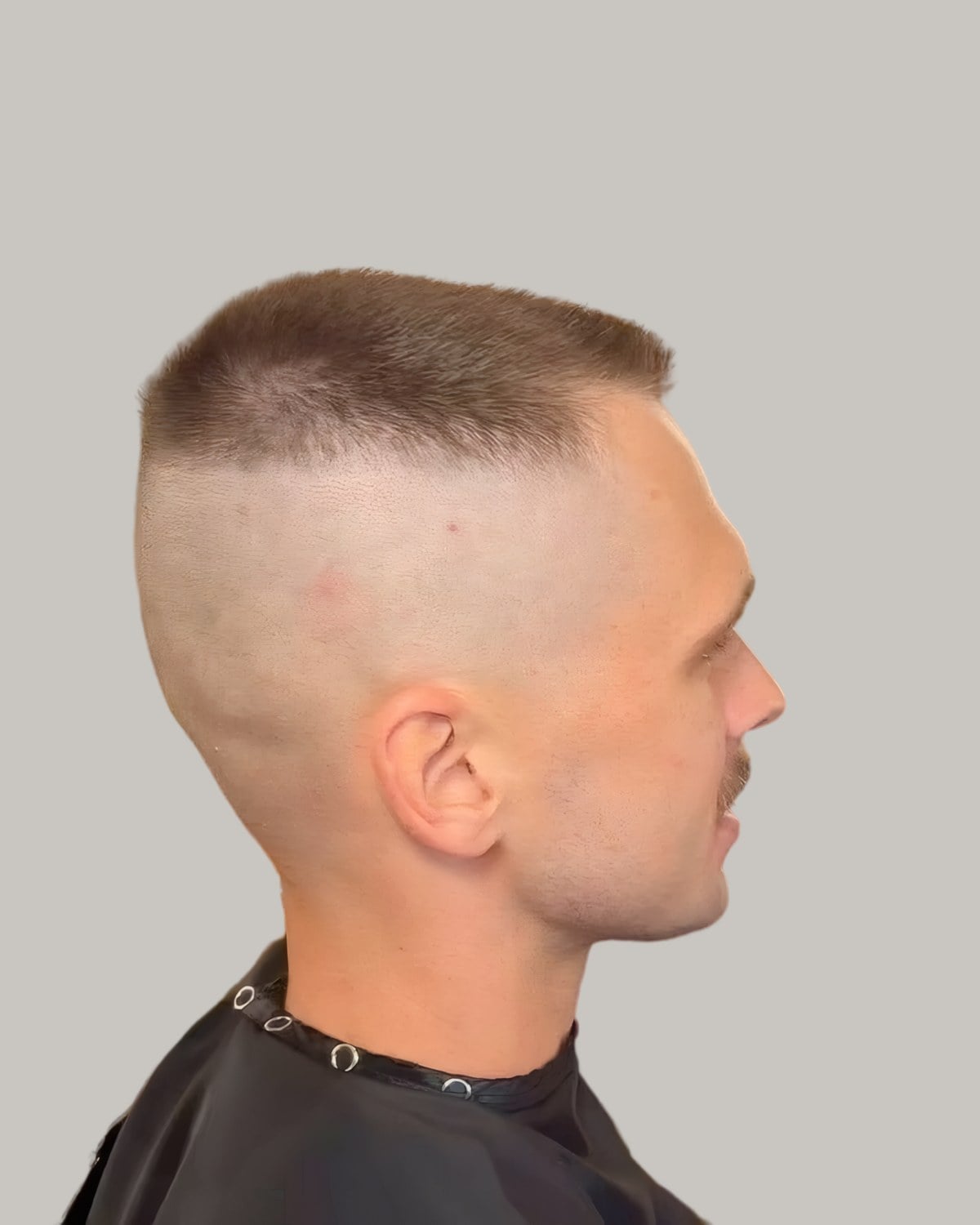 Man with a high and tight cut, seen in profile