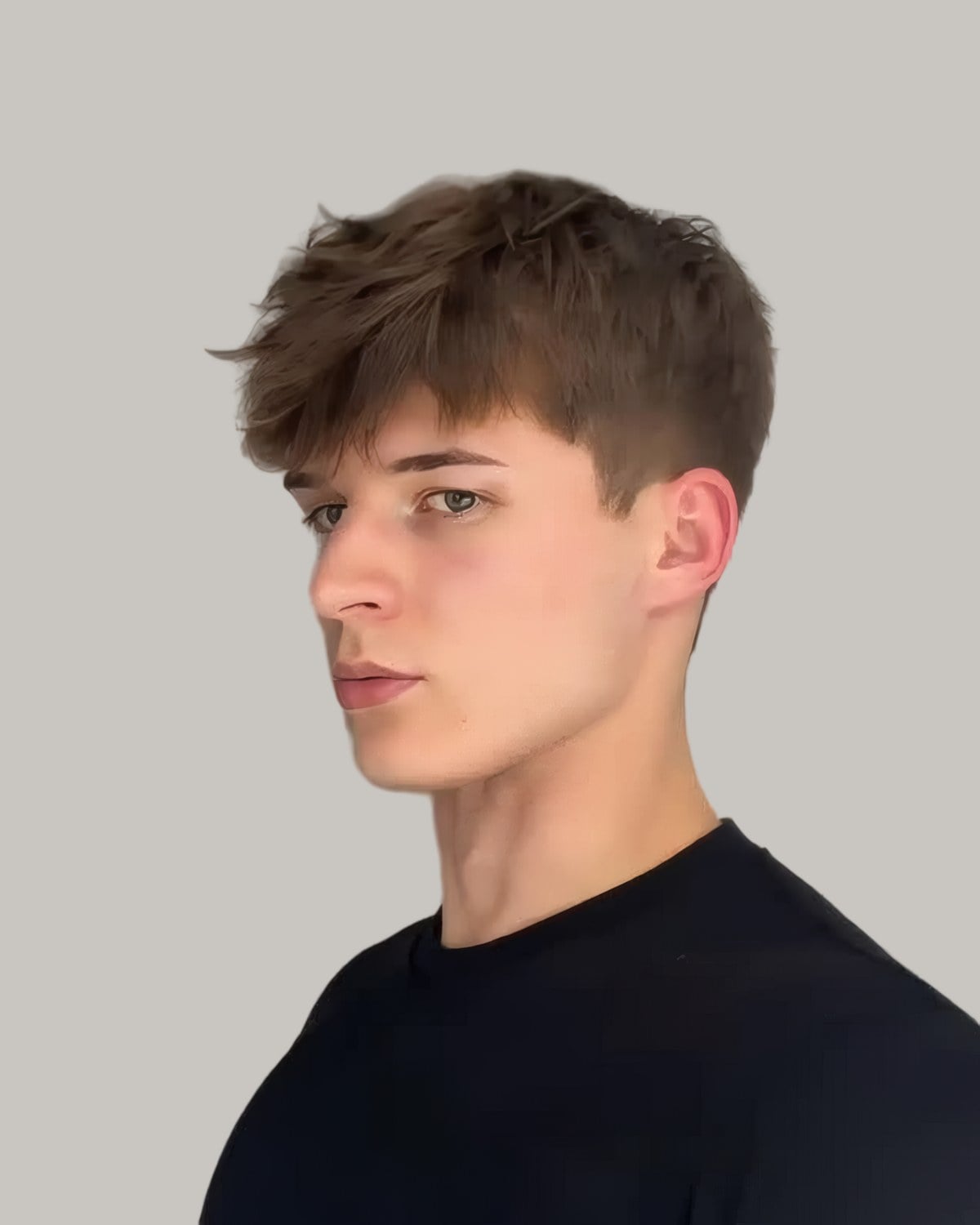 Young man with a long textured fringe, seen at an angle