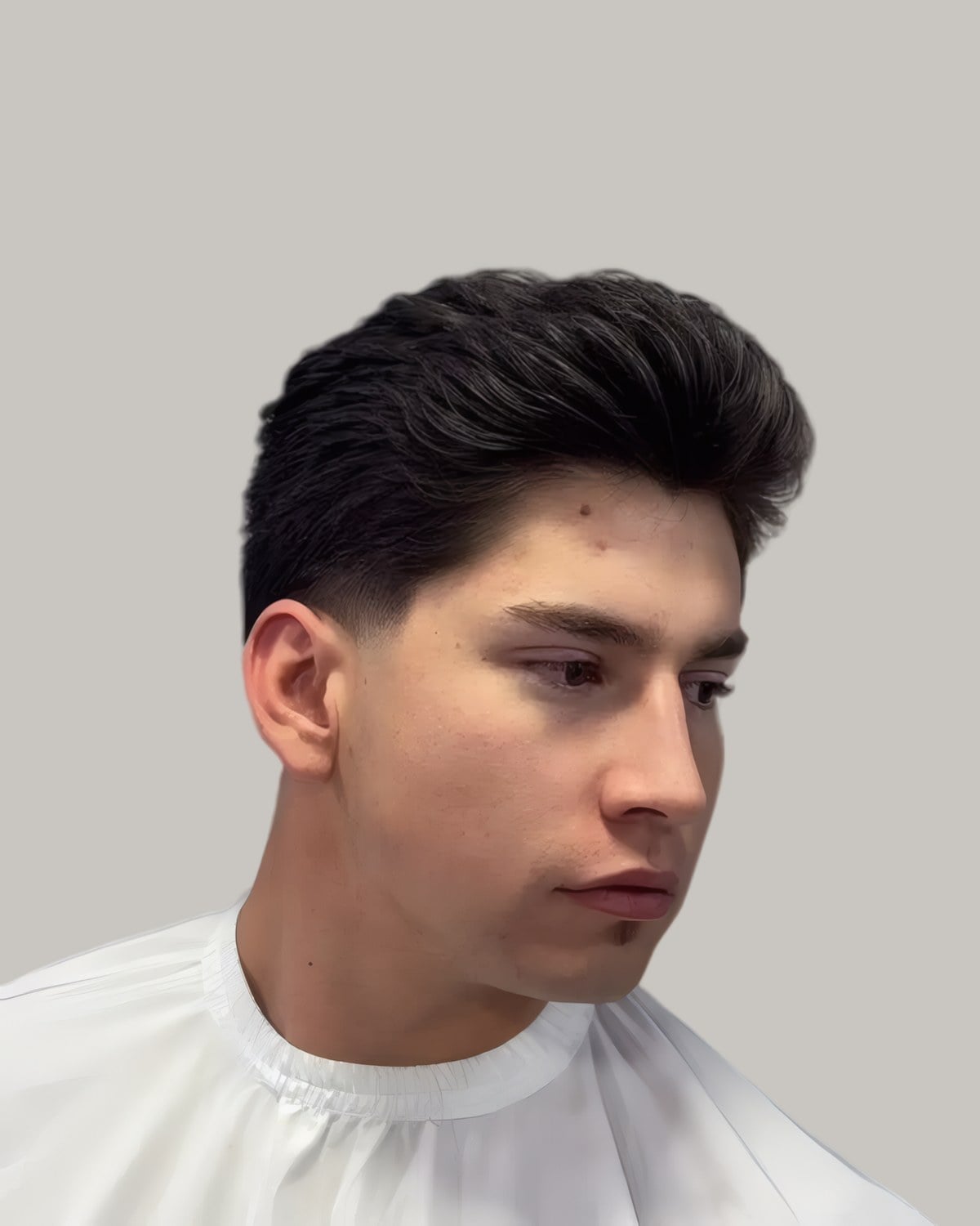 Young man with a dark pompadour, seen in profile