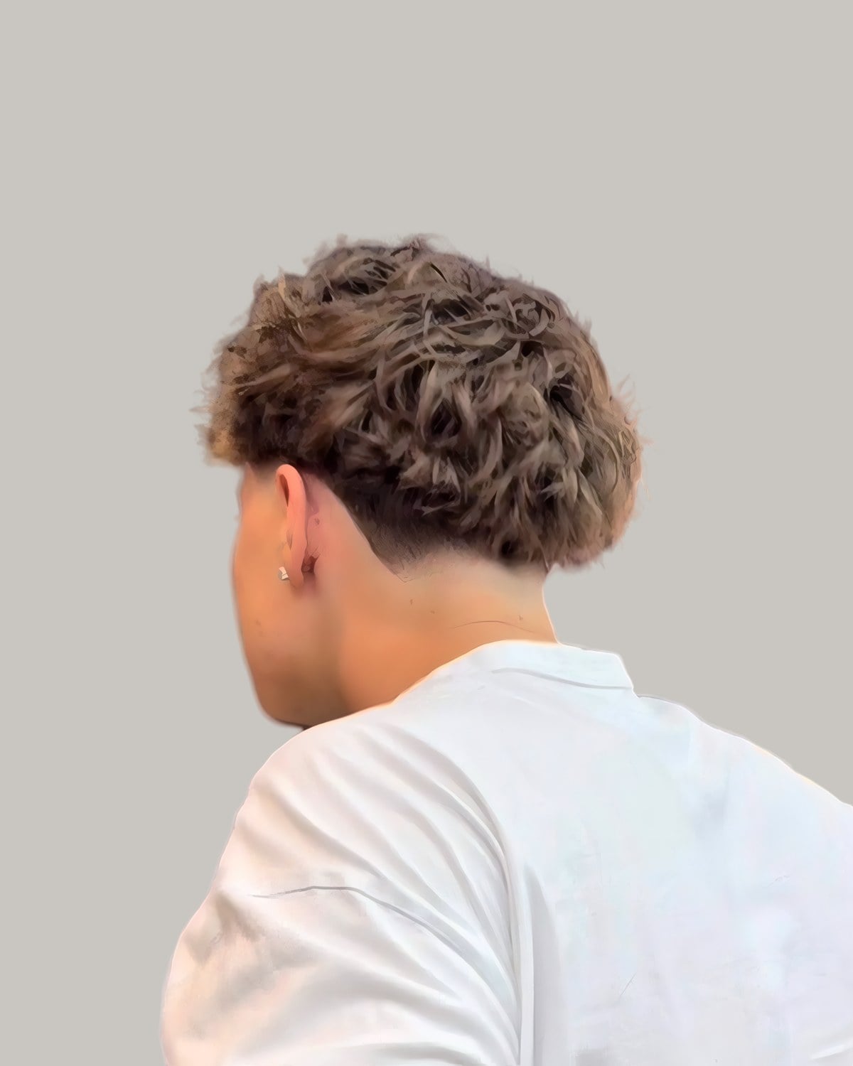 Man with a fluffy blow-dried top, seen from behind at an angle