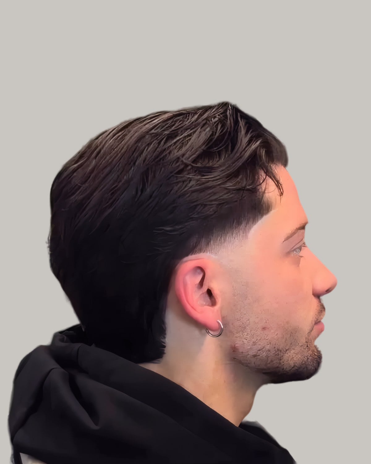 Man with a side-swept top and a taper, seen in profile