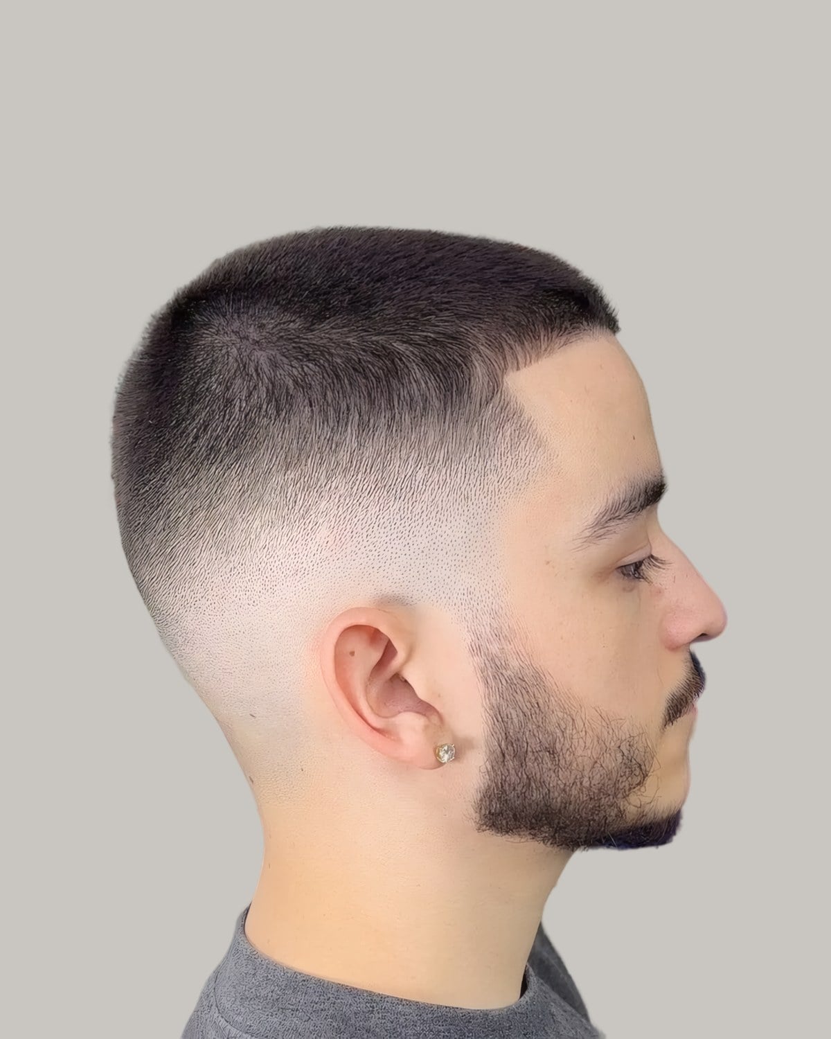 Man with a short crop, a beard and a skin fade, seen in profile