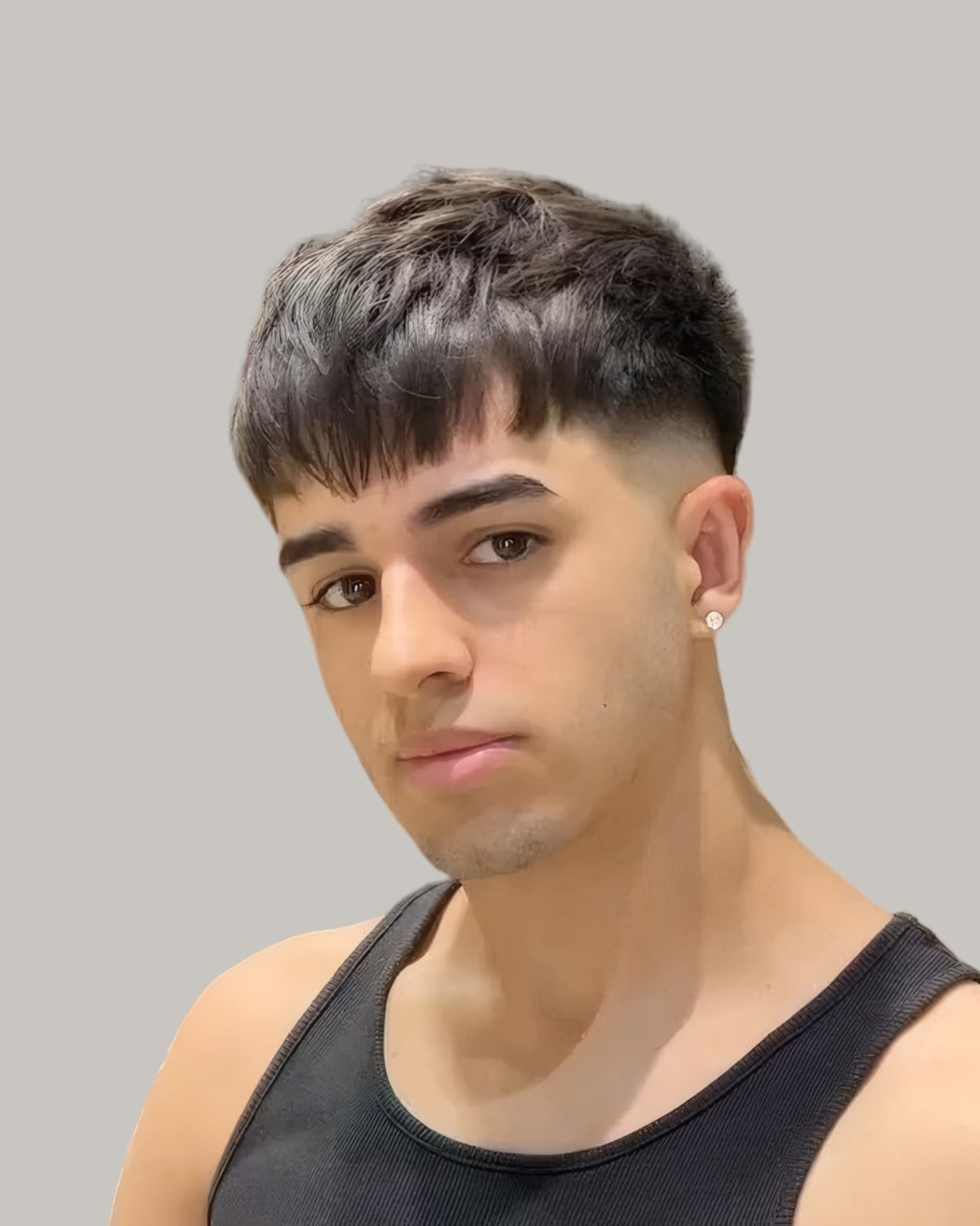 Man with a textured crop and a low fade, seen from the front