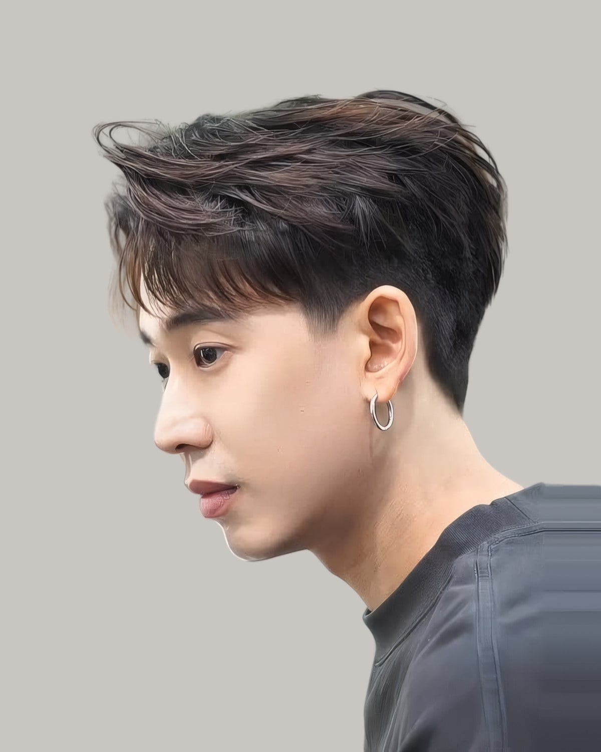 Man with a brushed-up undercut, seen in profile