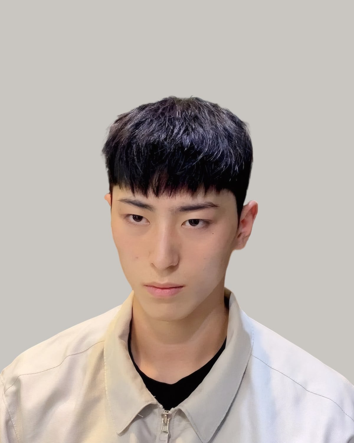 Young Korean man with a heavy textured fringe and scissor-cut sides, facing the camera