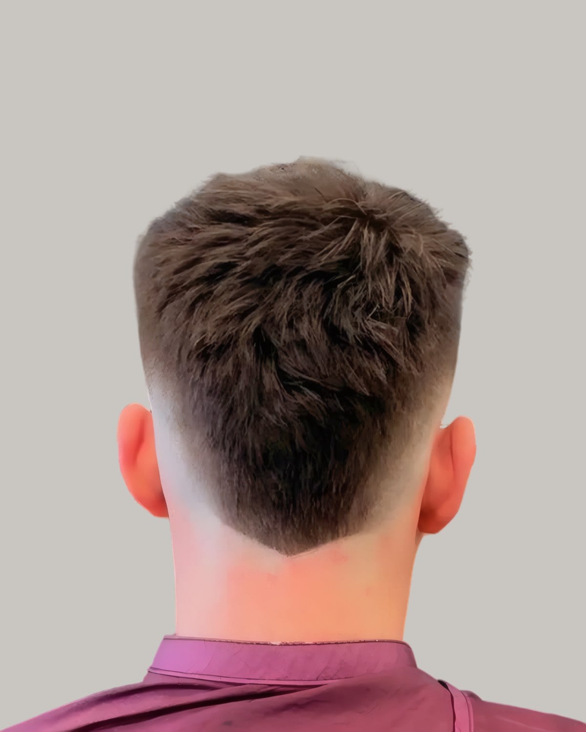 Back of a man's head with a textured crop and a V-shaped tapered neckline
