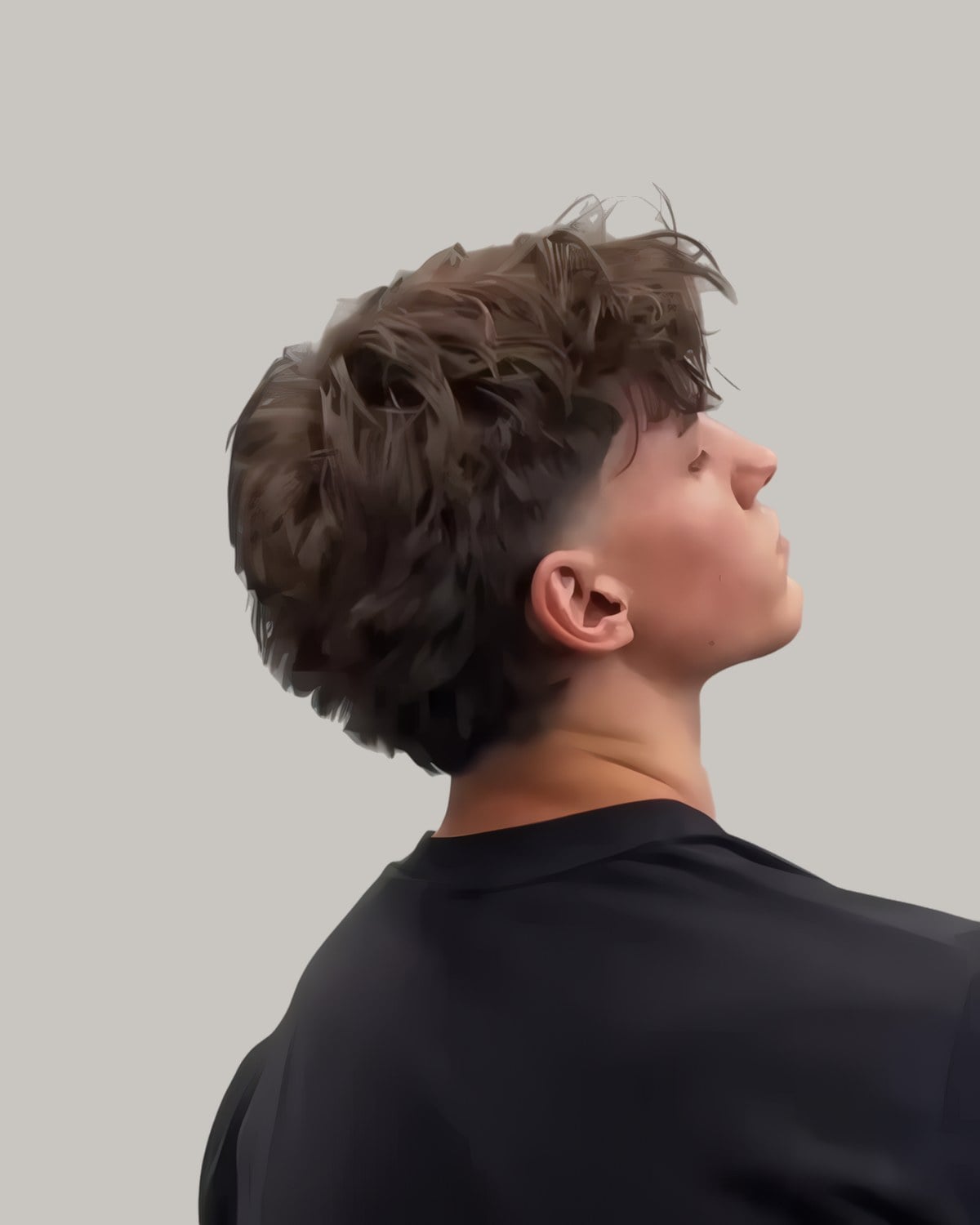 Young man with a longer textured top, seen in profile looking up