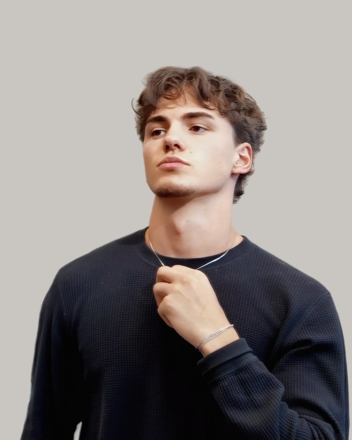 Young man with a longer brown textured fringe, looking up to one side