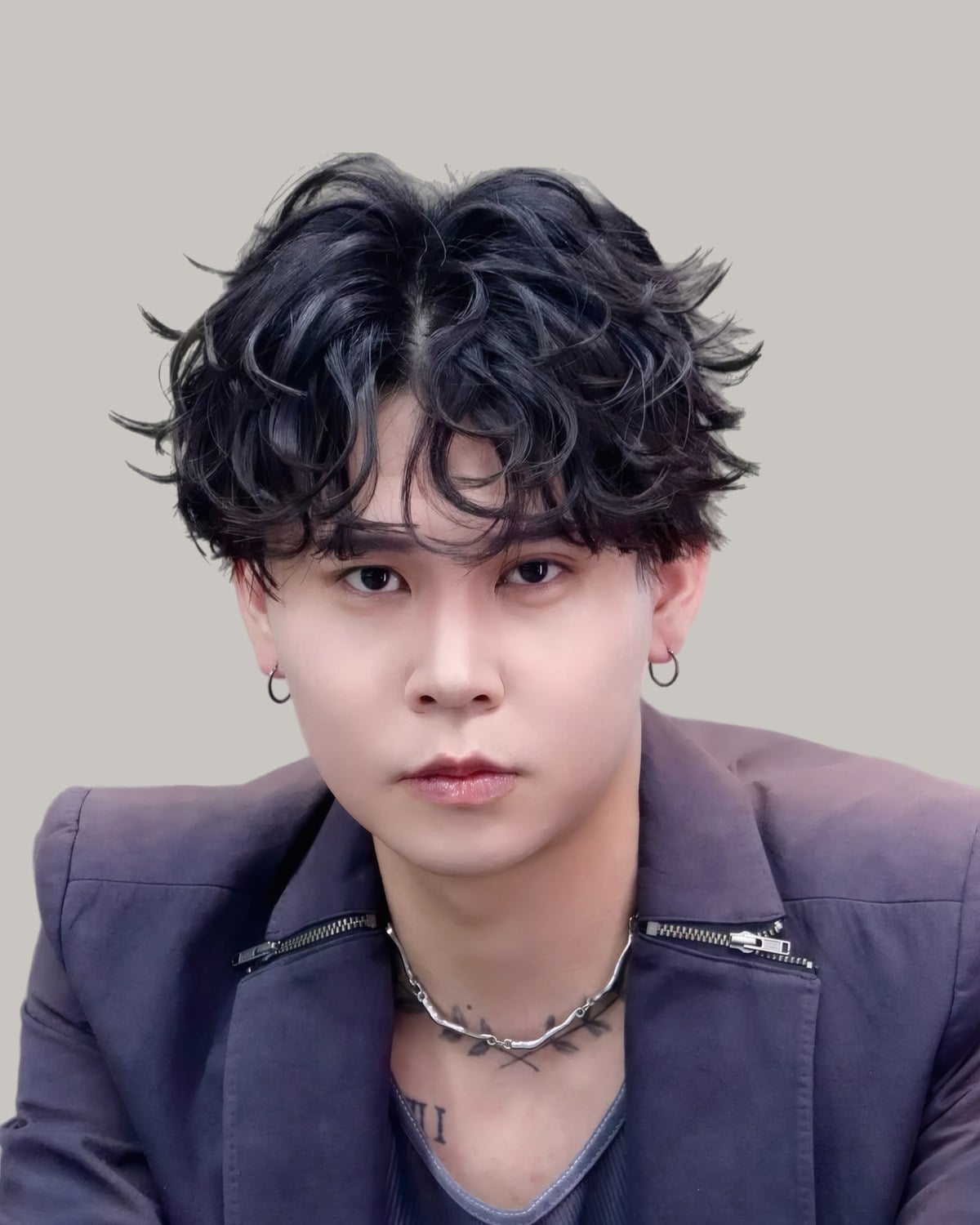 Young Asian man with a permed, wavy fringe, facing the camera
