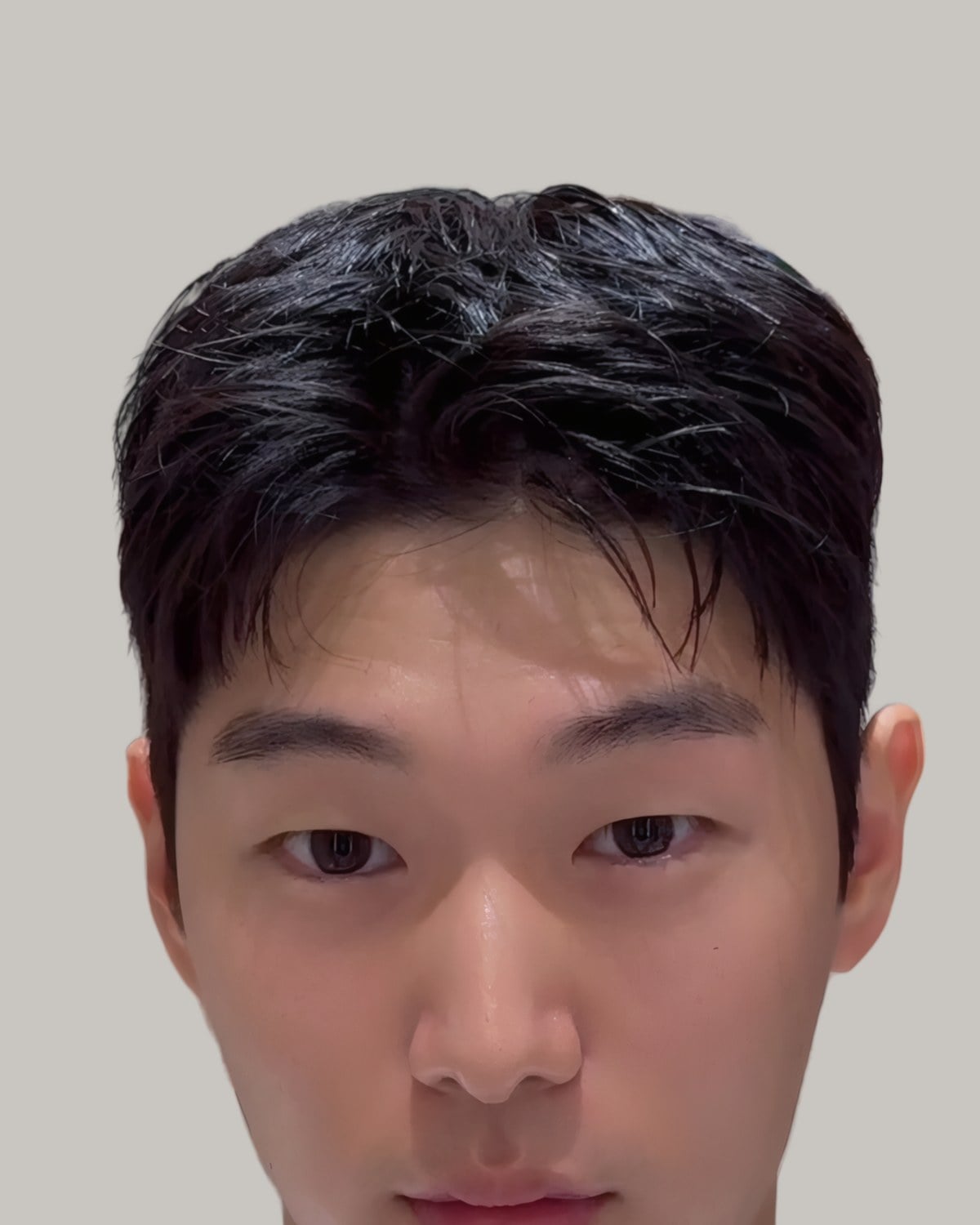 Young Asian man with a short dark textured fringe, facing the camera