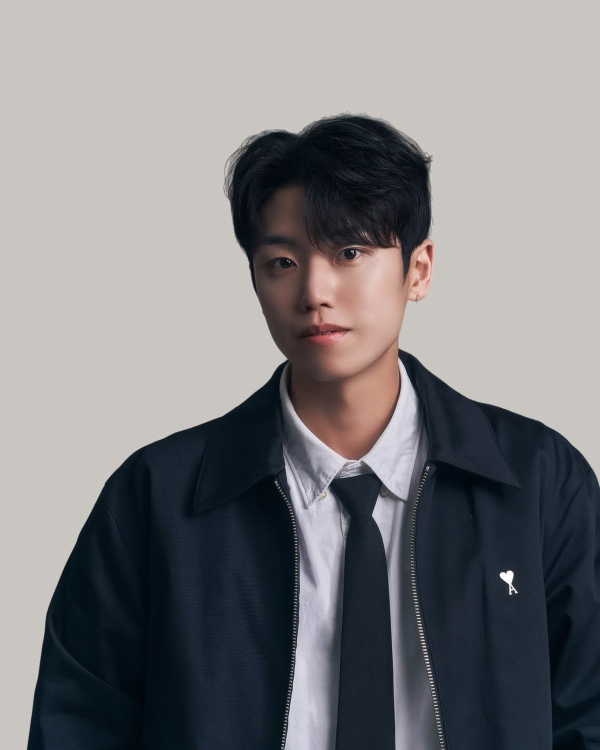 Young Asian man with a short textured fringe, wearing a shirt and tie