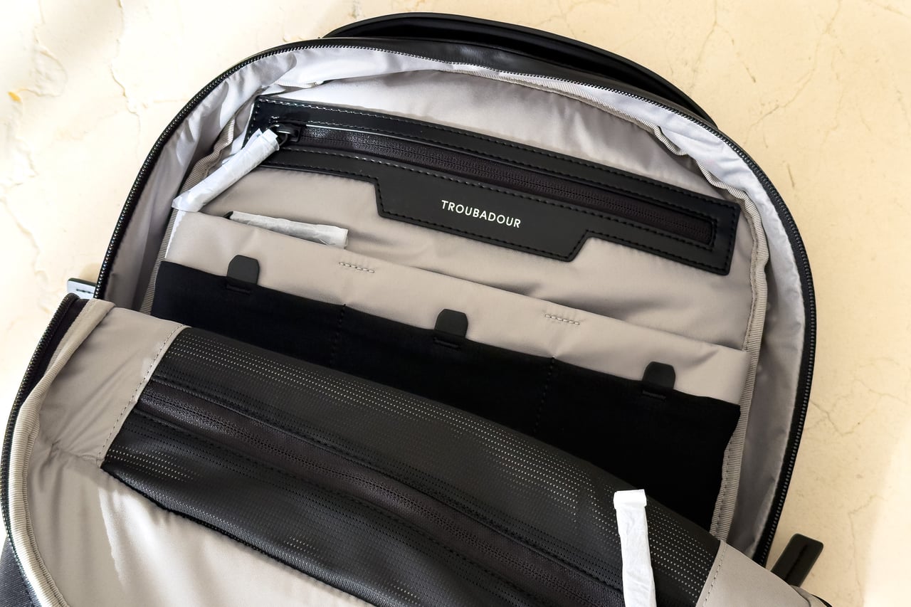 Protective covers on the Troubadour Apex Backpack's zippers before first use - Luxe Digital