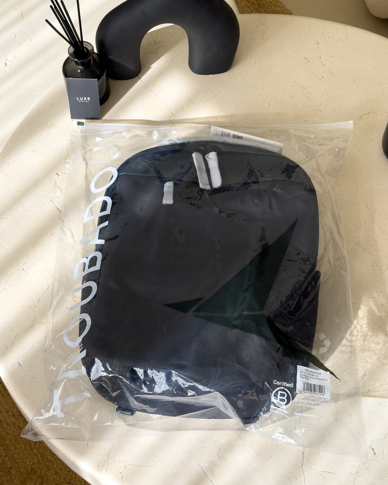 Troubadour Apex Backpack 4.0 in its recycled protective packaging bag - Luxe Digital